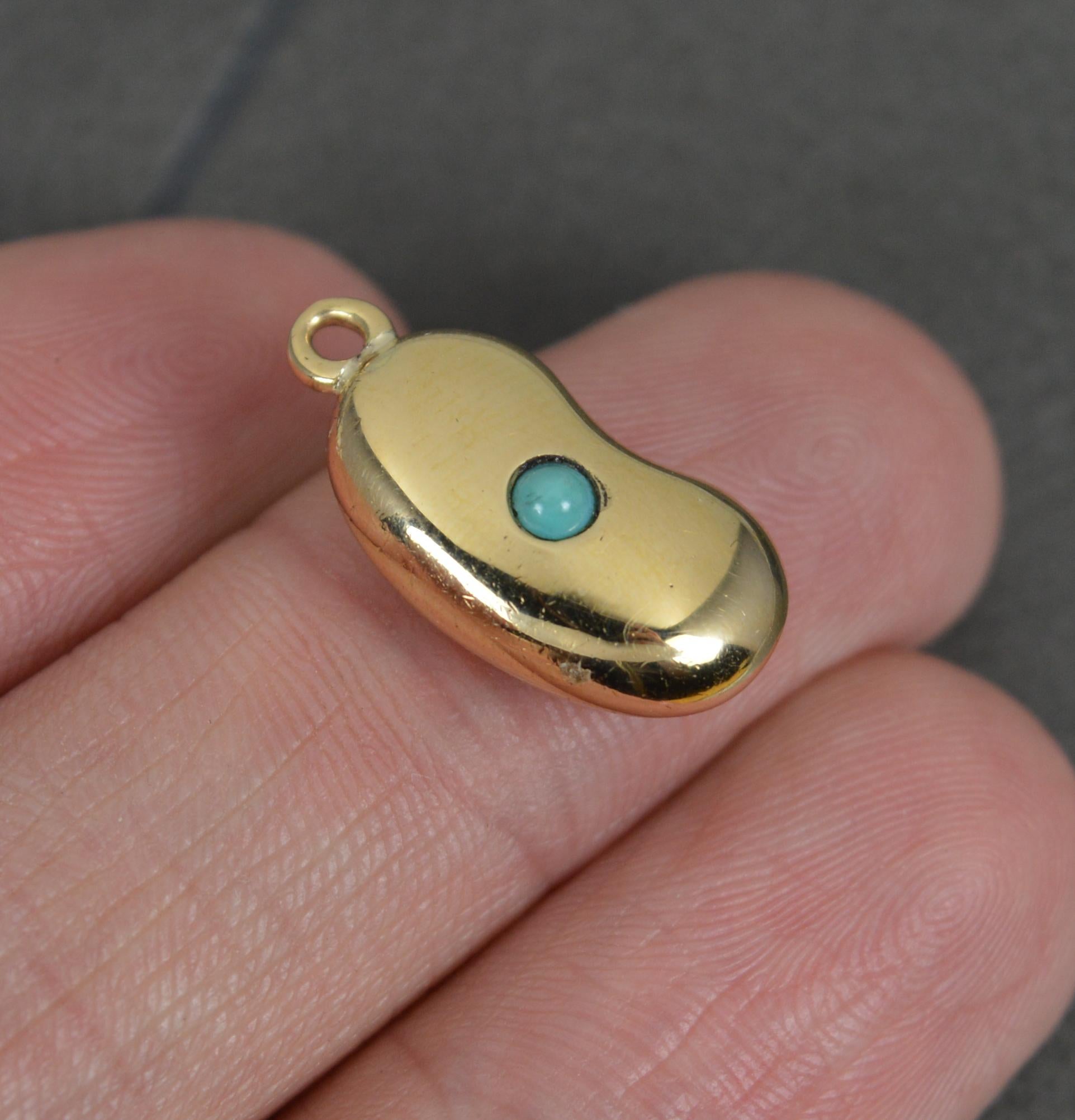 A superb English made Victorian kidney bean charm pendant.
A rare and collectable find. 
Solid 18 carat yellow gold example set with a single turquoise bead.
Circa 1880.
CONDITION ; Very good. Crisp design. Well set stone. Issue free. Please view