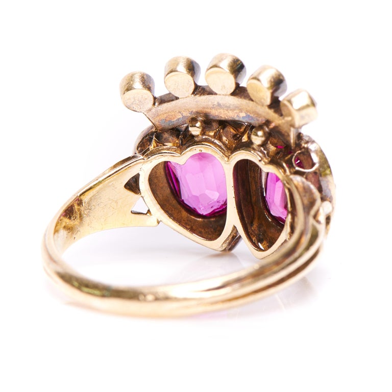 An incredible Victorian pink sapphire and diamond double heart ring, circa 1880. Set with two oval-cut unheated Burmese sapphires in an intense shade of delicious pink. Burmese pink sapphires are rare, particularly a matching pair of this size,