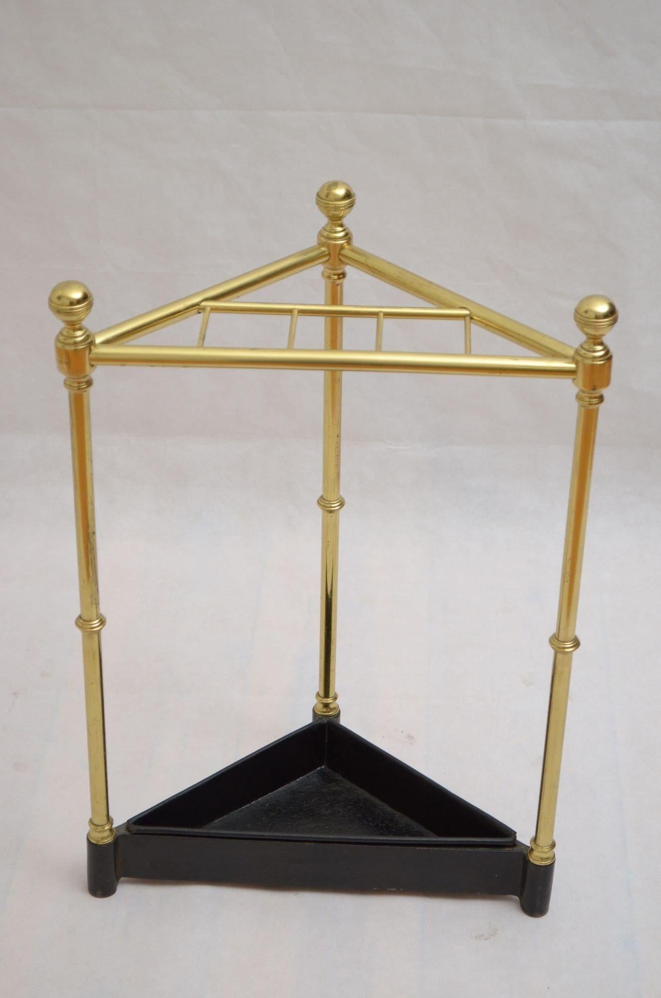 0285 Rare Victorian corner umbrella stand or walking stick stand in brass, having six compartment flanked by decorative reeded finials stamp with registration mark, raised on three ringed uprights terminating in cast iron base with removable drip