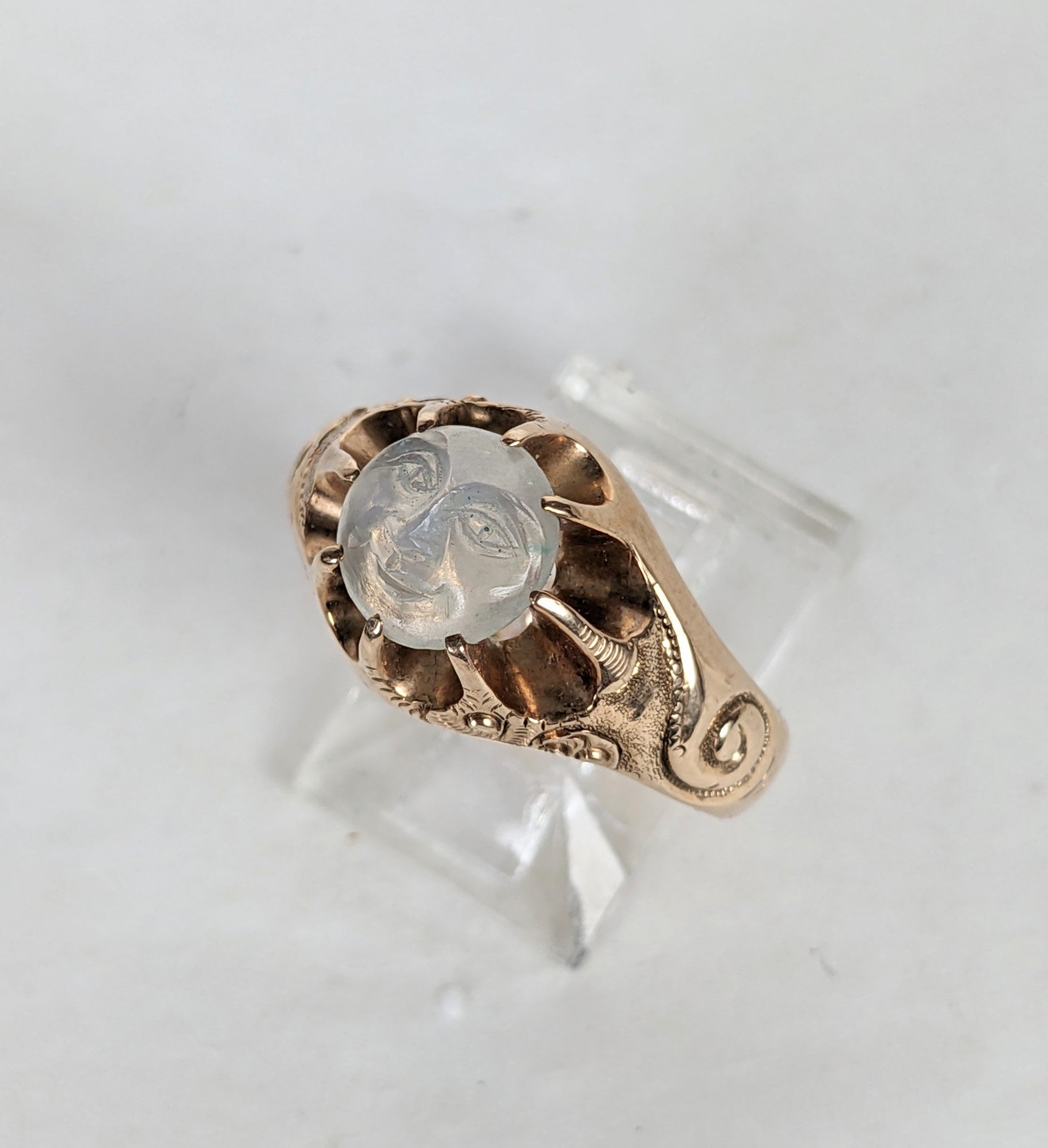 Rare Original Condition Victorian Man in the Moon Ring from the 19th Century in 14K gold. Original moonstone carved smiley face set high into pronged settings which give the appearance of sunburst with scrolls of clouds, hand engraved on shoulders