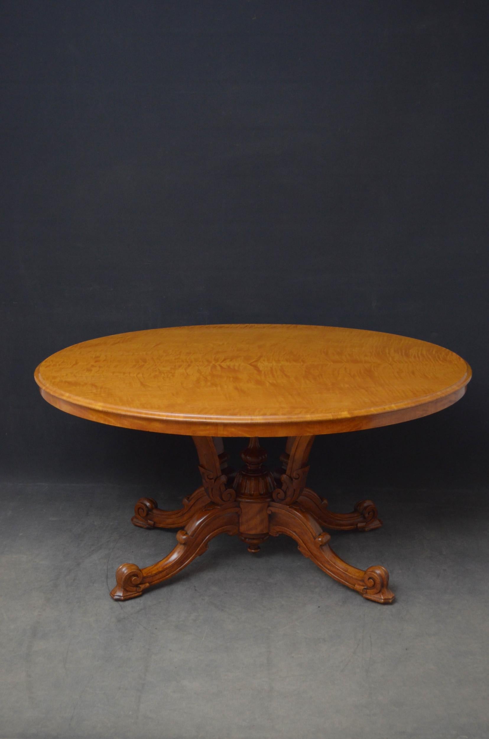 Sn5084 Outstanding Victorian satinwood centre table, having stunning oval top with moulded edge raised on four shaped and carved supports united by fluted finial and terminating in four cabriole legs with scroll feet, standing on original brass