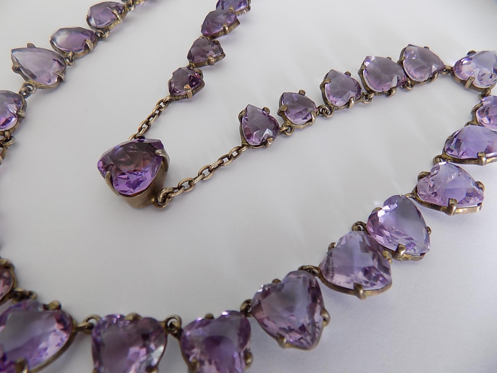 Outstanding Victorian solid silver gilt and heart shaped natural Amethyst Riviere necklace.  Rare find.
Total length including clasp 17 1/2