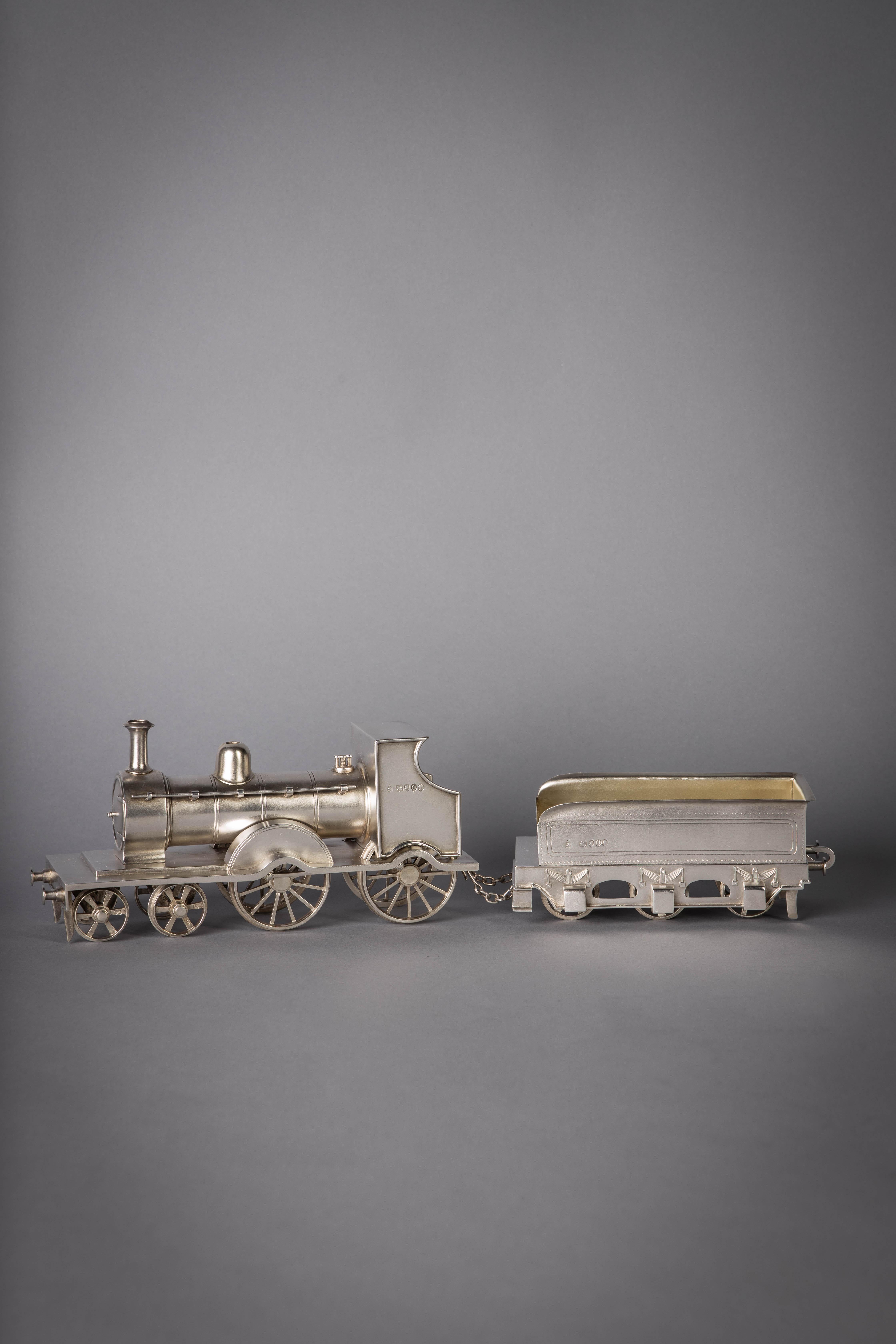 Steam locomotive pulling an open car. Marked: London, 1889, Maker: Alfred Benson and Henry Hugh Webb.