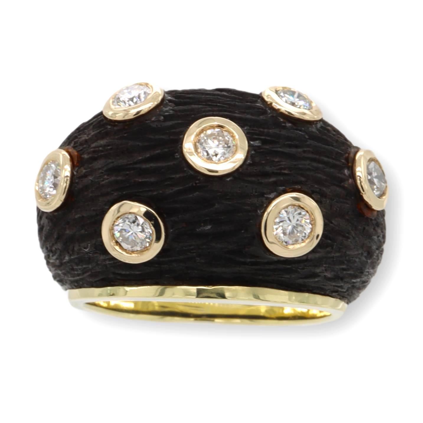 Rare vintage cocktail ring finely crafted in black wood sitting on top of 18 karat yellow gold adorned with 7 round brilliant cut diamonds set in bezels weighing 0.56 cts total weight approximately ranging VS-SI clarity. This ring has a bombay domed