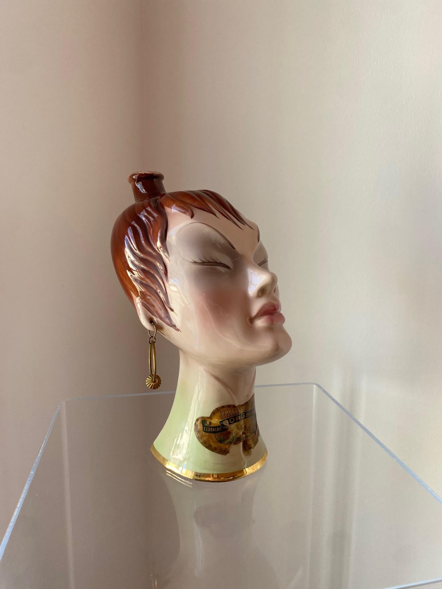 Vintage, ceramic and rare sculptural decanter in the shape of a female bust.  This beautiful piece exhibits chinoiserie details and is delightfully finished.  The piece exhibit beautiful finishes stylistically relevant to the 1950’s (mannequin style