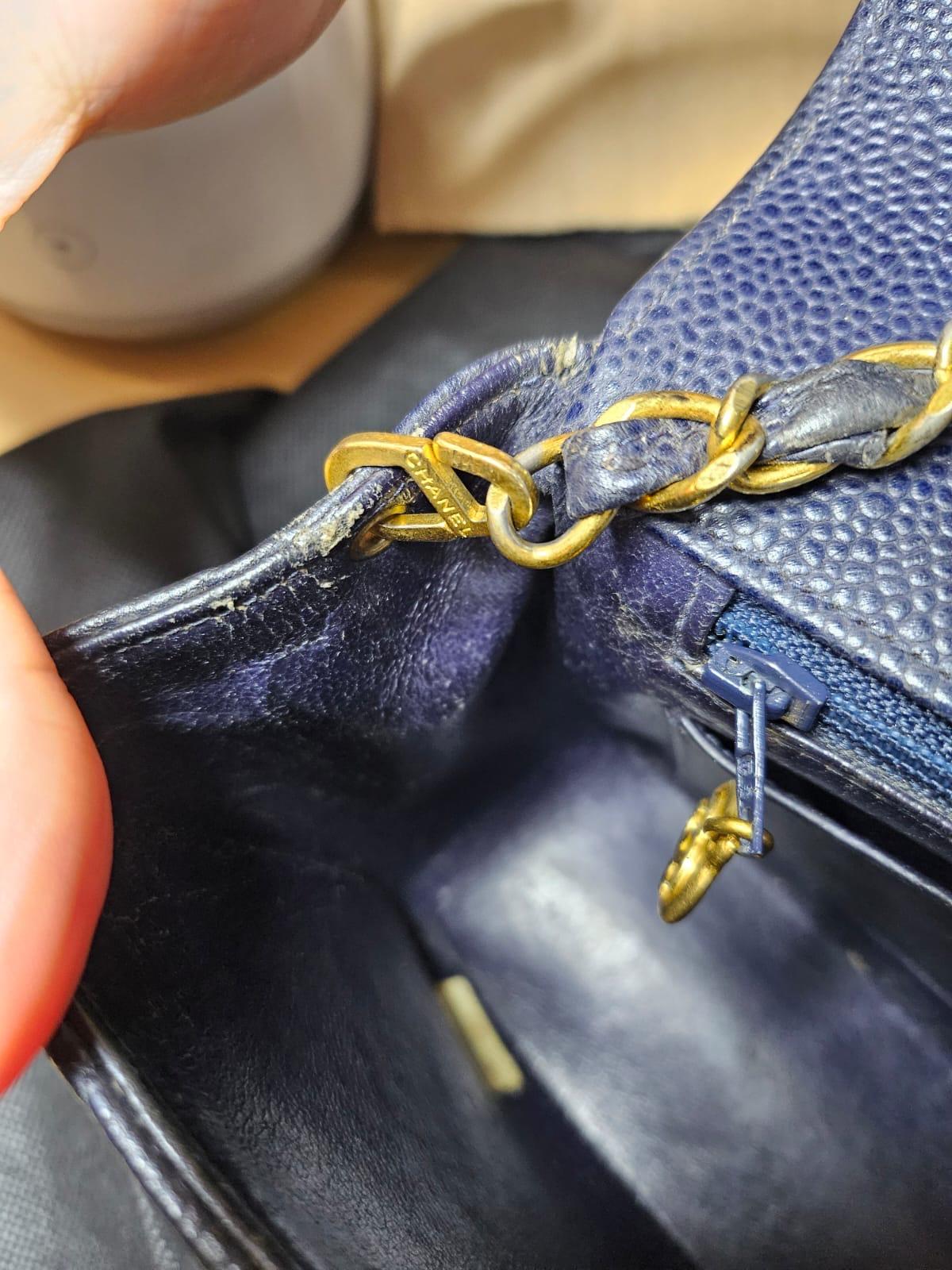 Vintage classic small diana bag in navy almost black caviar leather with gold hardware. Slight creasing and rubbing on the leather corners and strap. Minor touch ups has been professionally done. Tarnishing on the chain hardware and rubbing on the