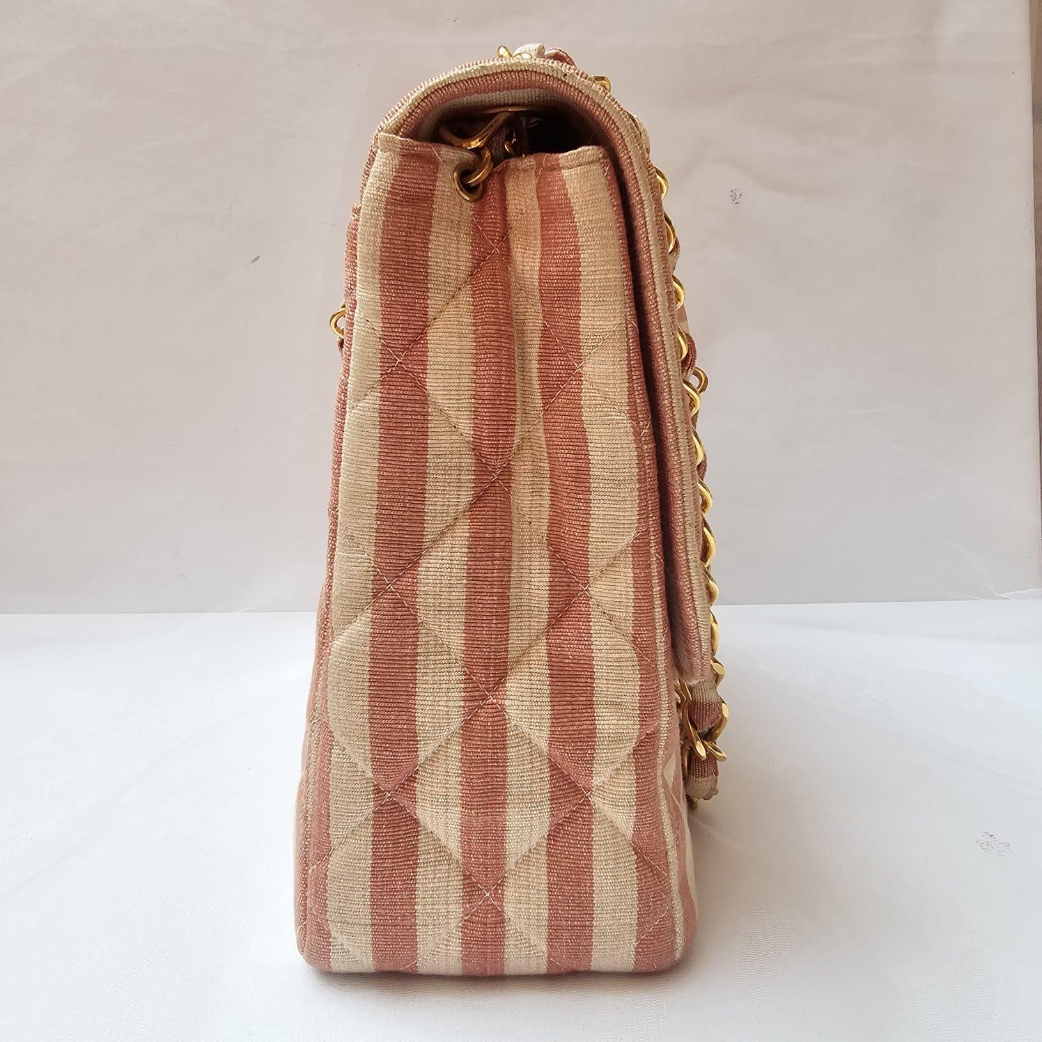 Rare chanel stripe square flap bag in pink and white with gold hardware. Rare collection from 1990s. Beautiful condition with very faint unnoticeable yellowing throughout the canvas surface. Holo still intact. Light marks on the strap. Series 3.
