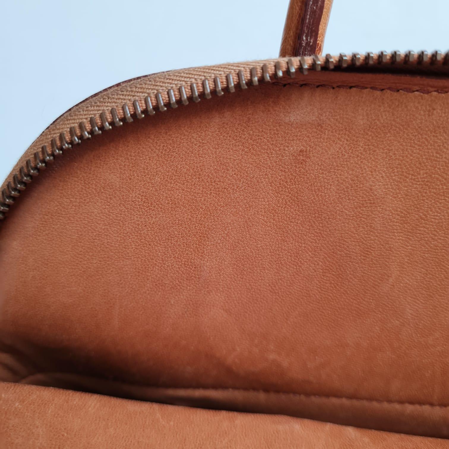 Classic vintage bolide in chestnut colour and gold hardware. Stamp circle Y from 1995. Overall still in good condition, with minor scuffs on some exterior leather and light scratches on the lining. Comes with its dust bag, strap, clochette, padlock