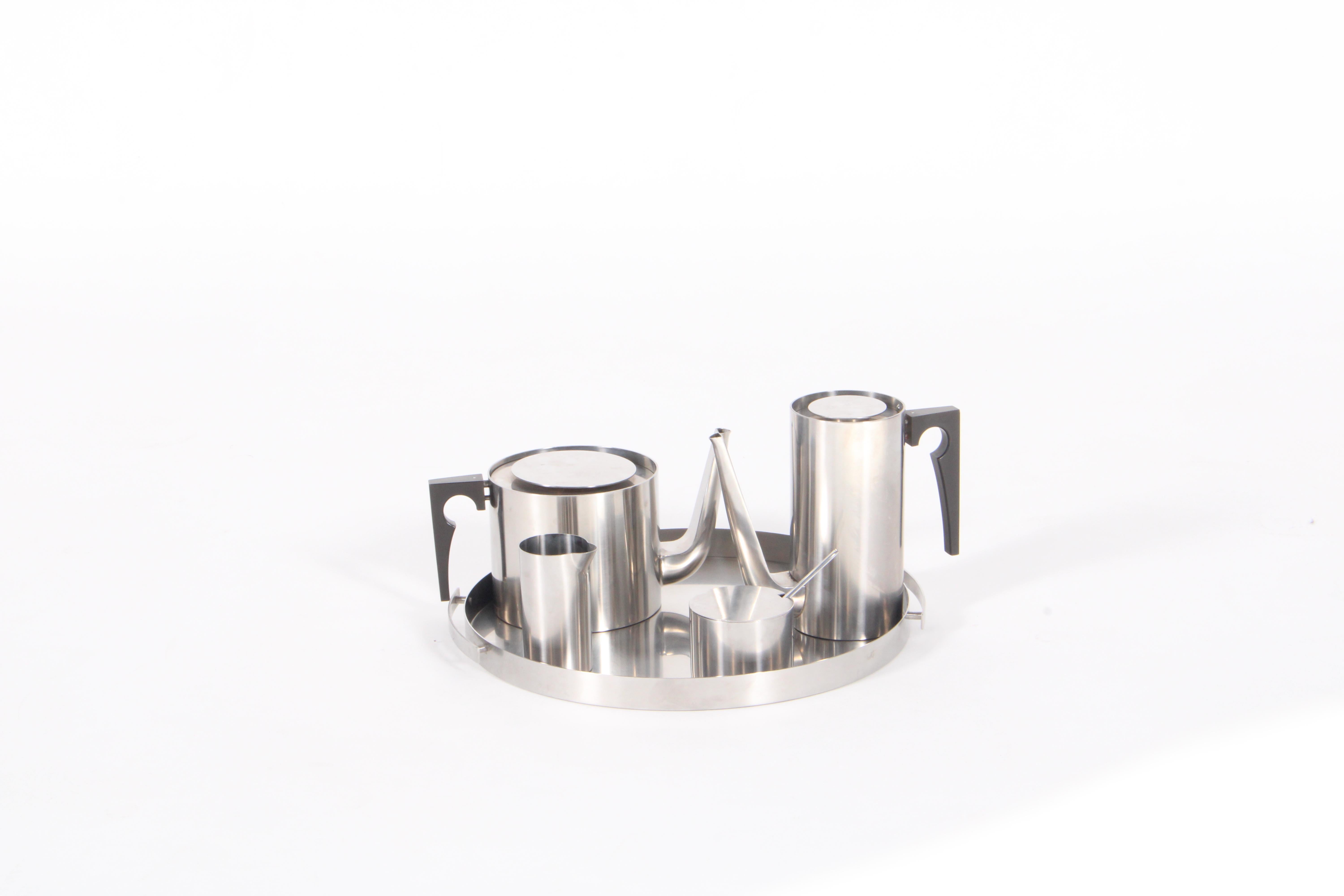Designed by one of the most internationally renouned designers Arne Jacobsen  this remarkably beautiful tea and coffee set is meticulously crafted in stainless steel with a sleek and stylish minimalist design. This set comprises of five different
