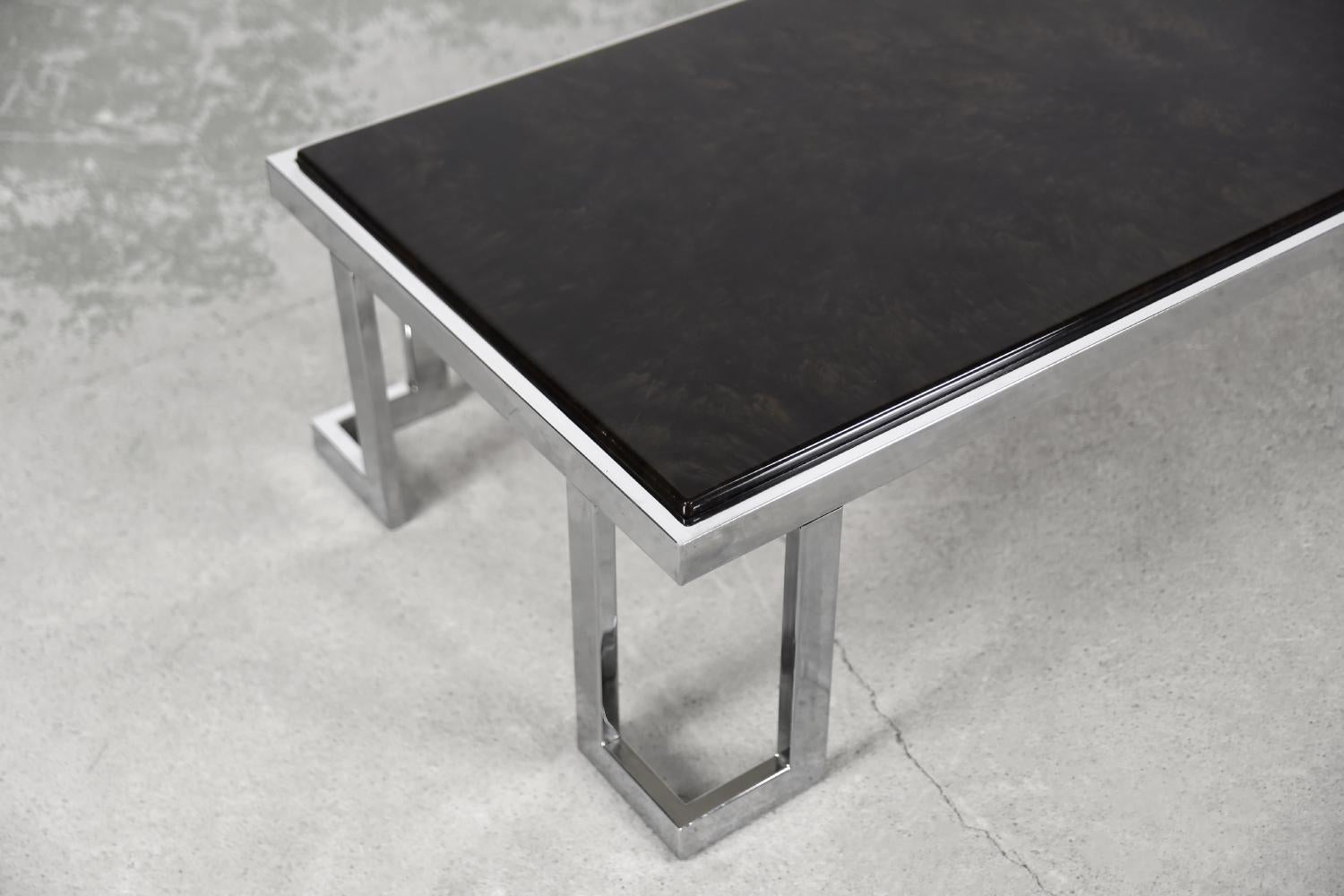 This brutalist coffee table was manufactured in Italy during the 1970s. The geometrical frame is made from chrome-plated metal. The top is made from epoxy resin with beautiful drawing and it look like tortoiseshell.

This item is in original