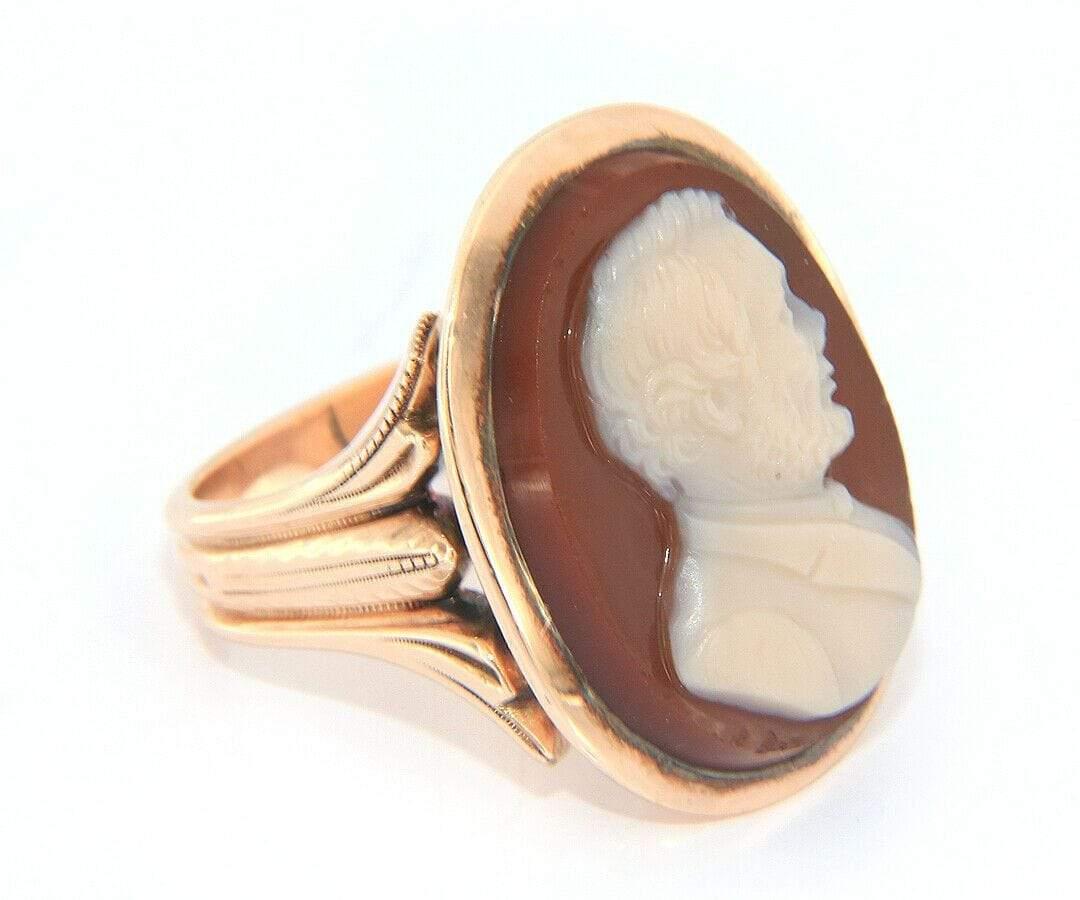 Rare Vintage Cameo Ring w/ Men’s Profile in 10kt Rose Gold

Rare Right Facing Men’s Face Cameo Ring
10K Rose Gold
Ring Size: 
Carved Agate Male Cameo
Measuring Apx 23.5 x 17.5mm
Measurement of Bezel Set Top 26 x 20mm
Weight: Apx. 11.90 Grams
