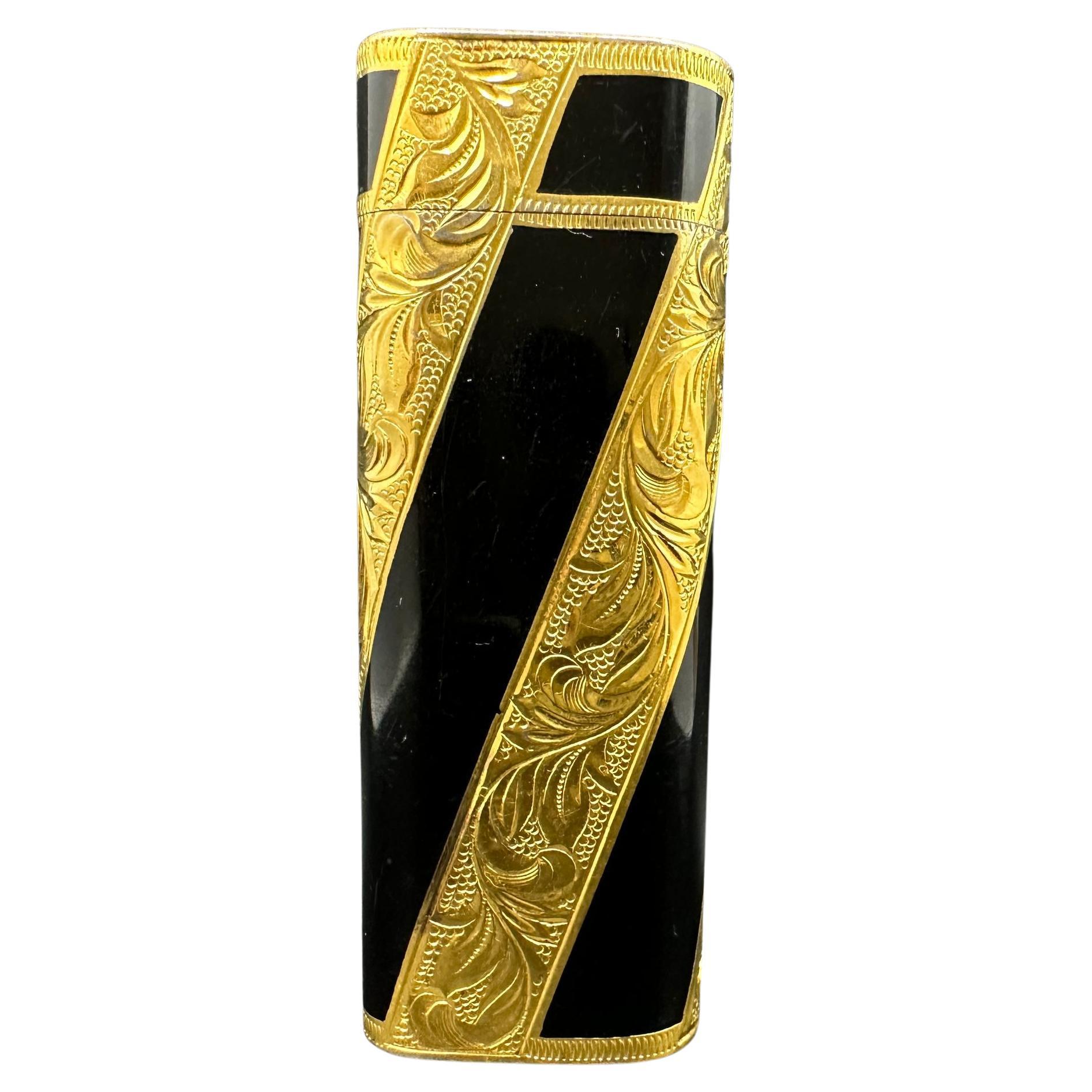 Cartier “Royking” lighter.
Circe 1980
CARTIER  Roy King Rollagas, a Unique RARE example of a ROYKING designed Cartier Rollagas lighter made circa 1980's, 18K Gold Baroque Inlay with Black lacquer, mint condition.
Roy King emblem on top side part of