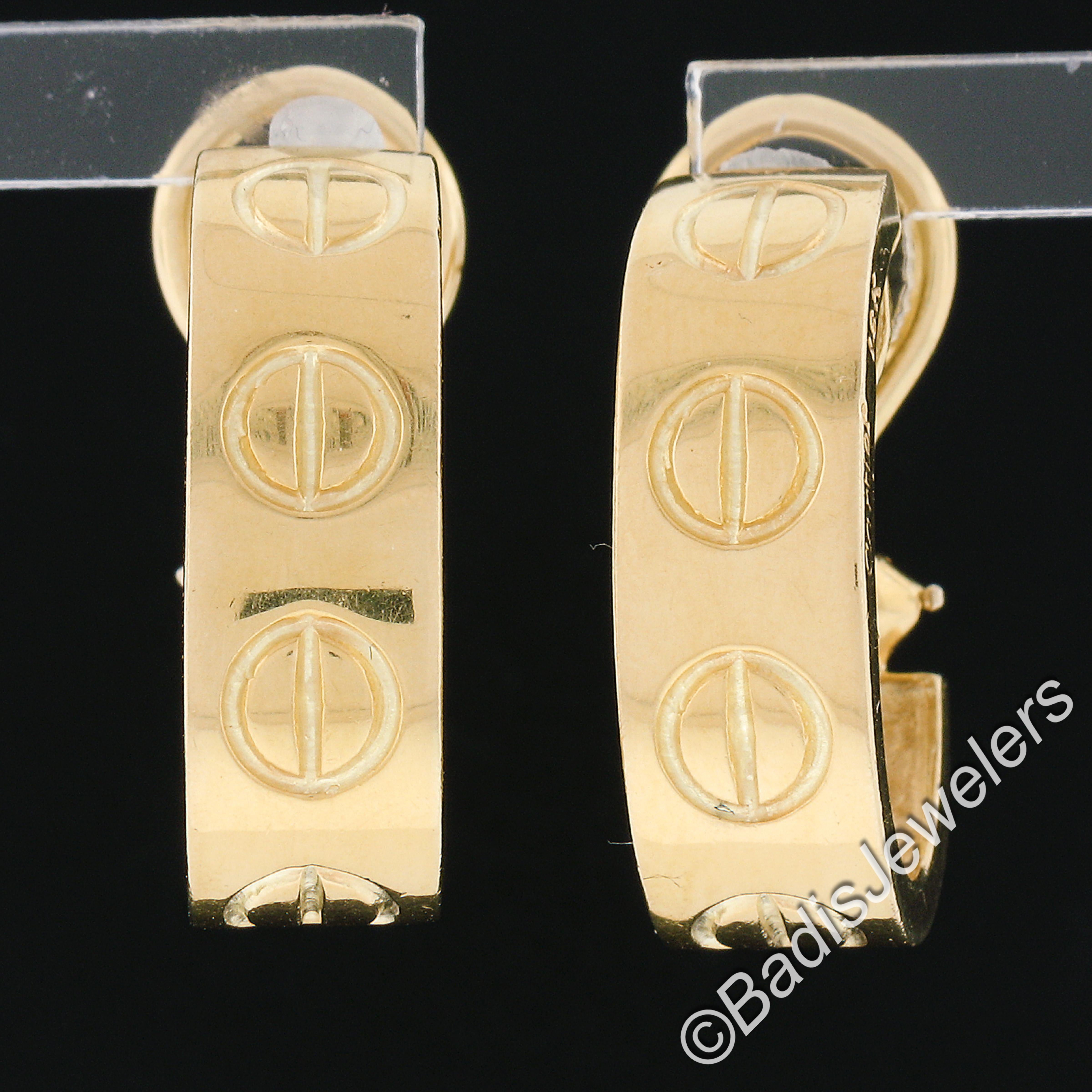 This rare vintage Cartier Love pair of earrings is crafted in solid 18k yellow gold and signed properly with the old Cartier cursive signature style. They have their original finish intact and they remain in excellent physical condition. They