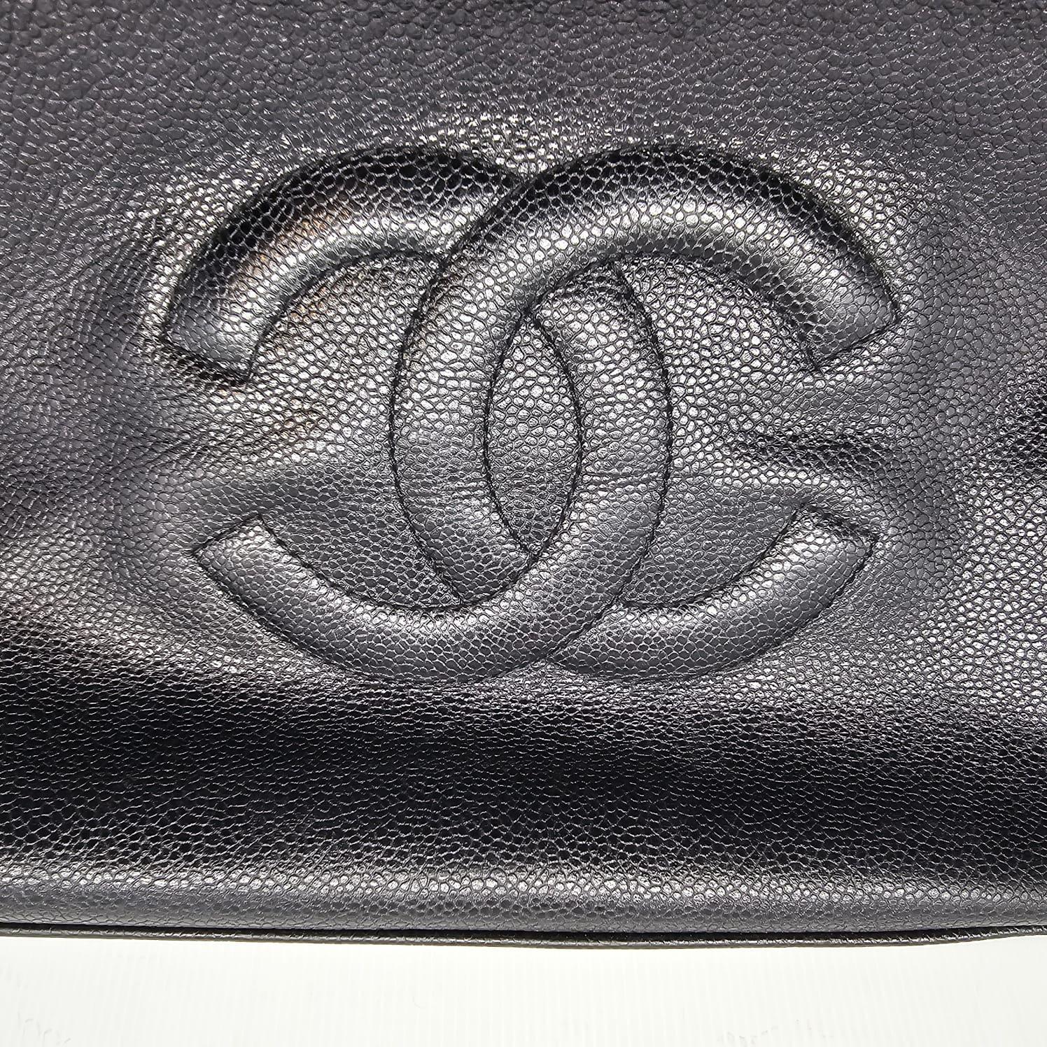 Rare Chanel Supermodel tote in black caviar leather with gold hardware. Item has slightly lost its shape, but sits fine when stuffed. Slight scuffing and rubbing on the leather body and corners. Series 4. Comes as is with the hologram intact. 