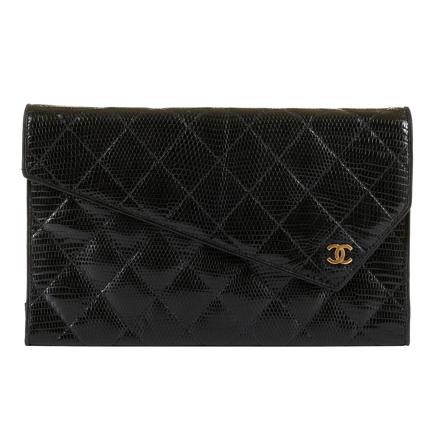 This rare Chanel black quilted, lizard clutch evening bag, designed by the legendary Karl Lagerfeld, is in excellent condition throughout. The classic envelope design is accented with gold hardware, highlighted with a gold iconic double 'C'  clasp