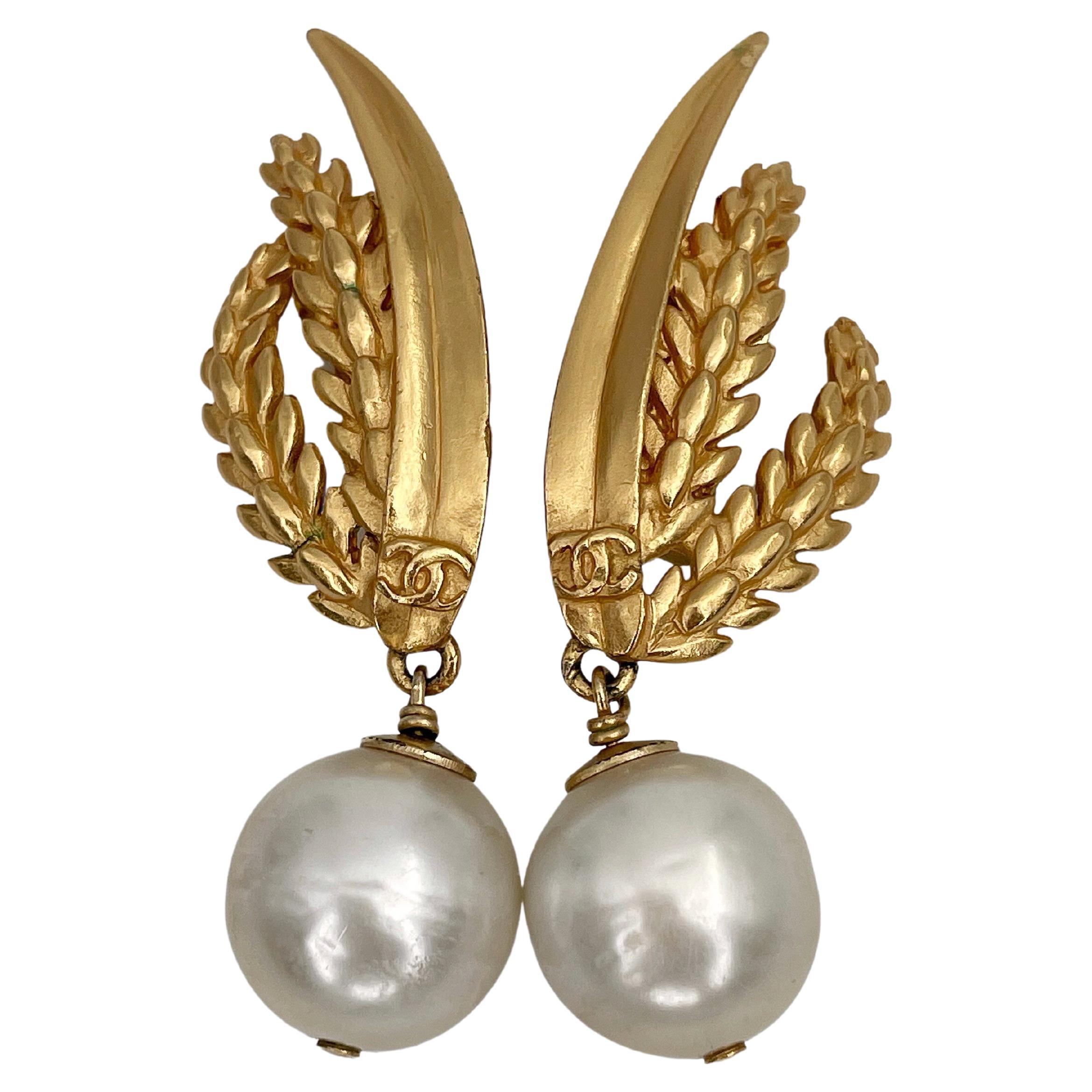 Vintage CHANEL gold tone earrings with a faux pearl, Swarovski crystal