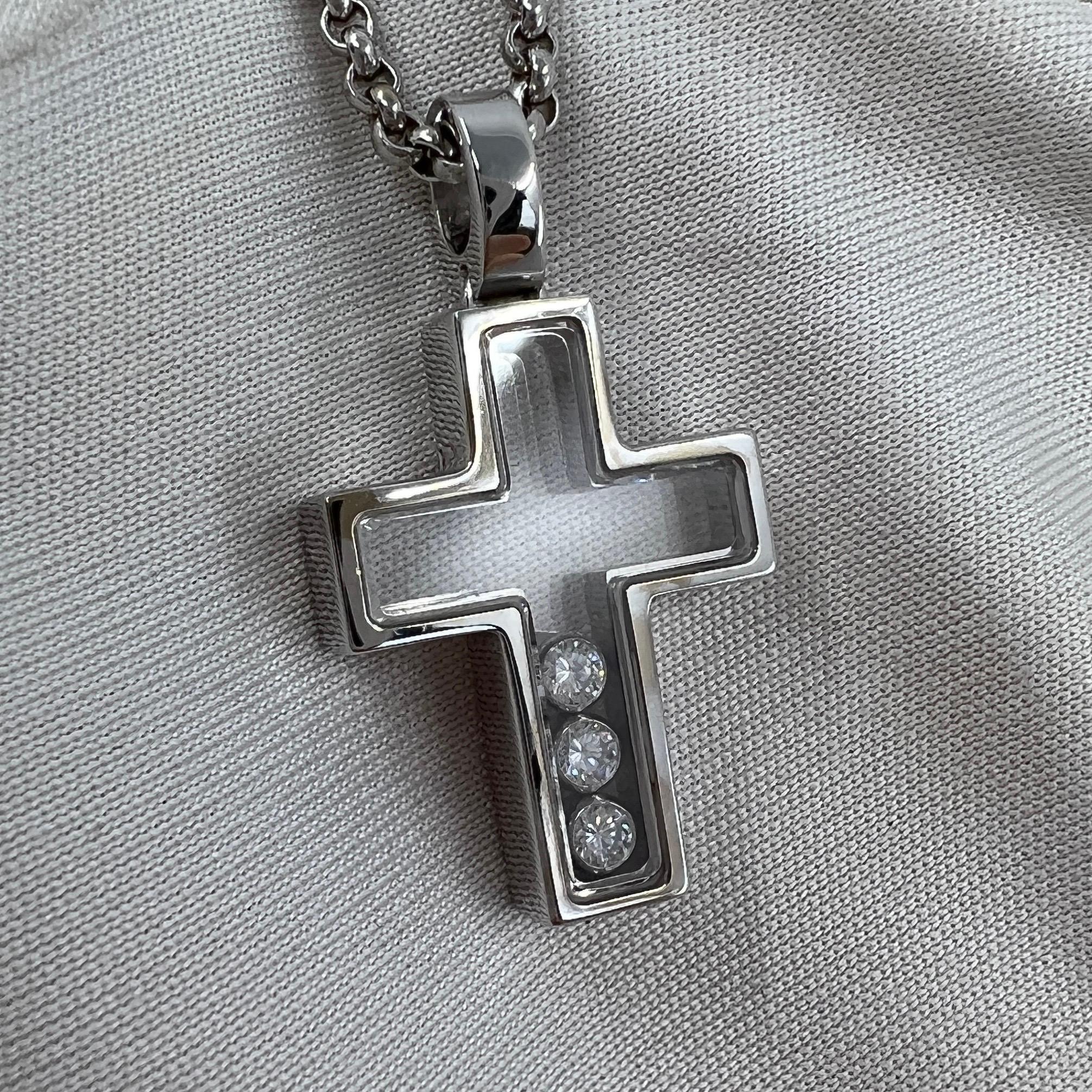 A Rare Chopard Happy Diamonds 18k White Gold Cross Pendant Necklace.

Inspired by drops of water, Chopard's Happy Diamonds Icons collection features diamonds that are free to swirl gracefully behind sapphire crystal glass, enhancing their sparkle