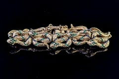 Rare vintage D'Orlan snake bracelet, gold plated, green crystal
