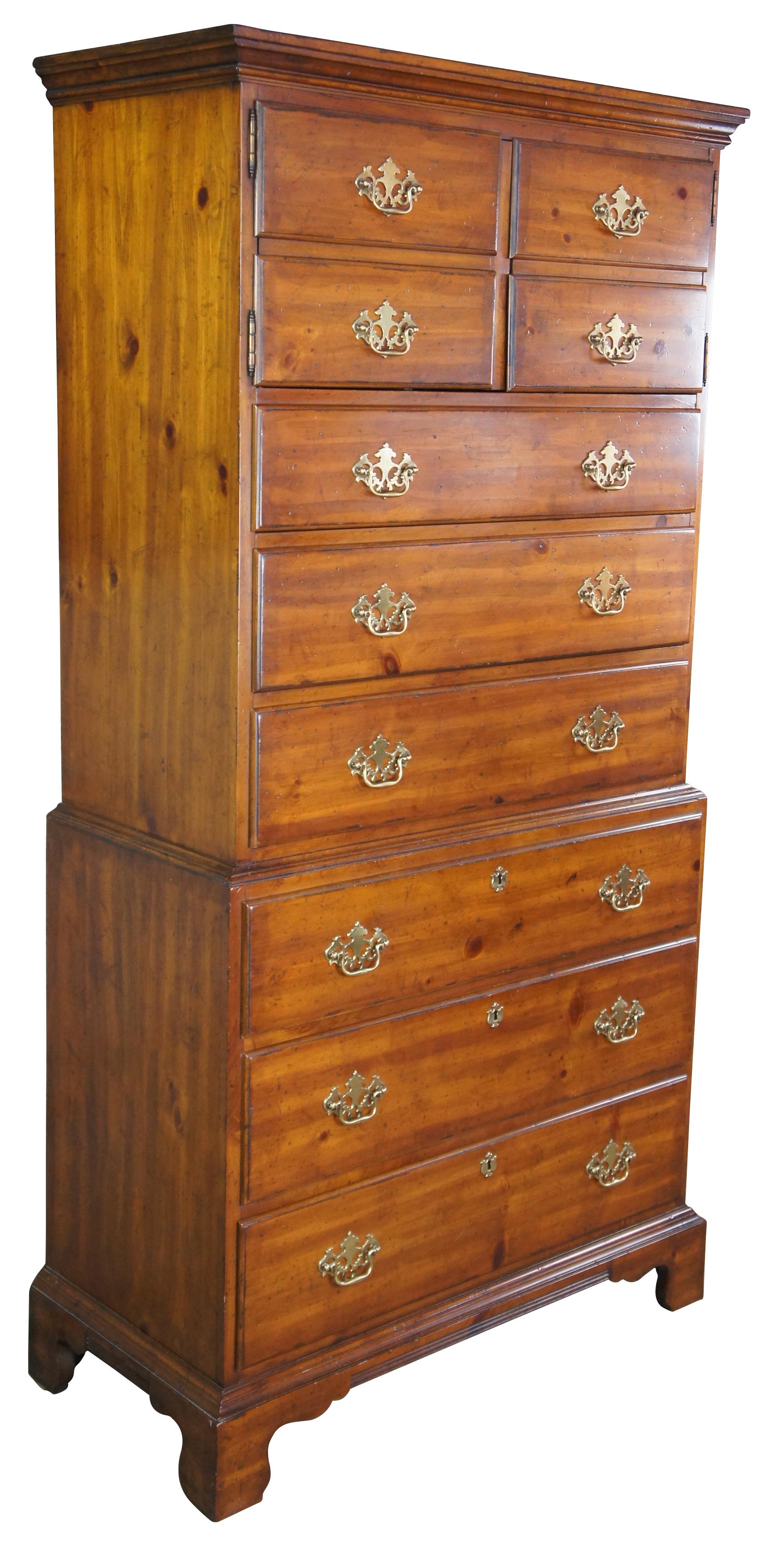 Drexel Heritage American Tour highboy dresser, circa 1960s. Made of pine featuring chest on chest design with six drawers and upper cabinet with three divided cubbies. Brass Colonial hardware and bracket feet. 170-430, American Tour I, Heritage,