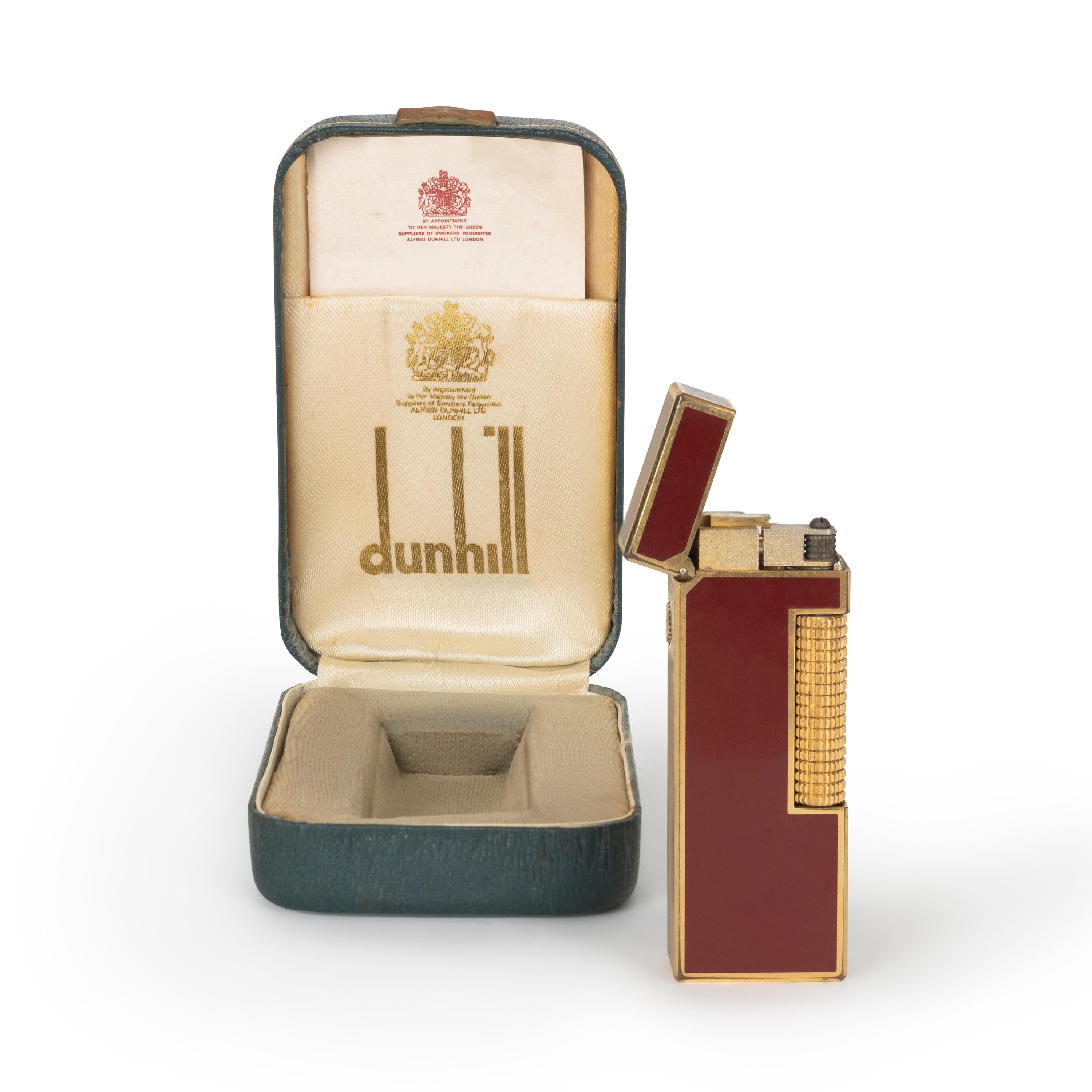 Vintage Dunhill Gold-Plated, Red lacquer Swiss Manufactured, Lighter
In Mint working condition. 
In original box. 
Brand: Dunhill.
Model: Rollagas.
Color: Red Lacquer/Gold.
Measures: 63cm x 23cm x 12cm.
Weight: 71g.
Made in Switzerland.