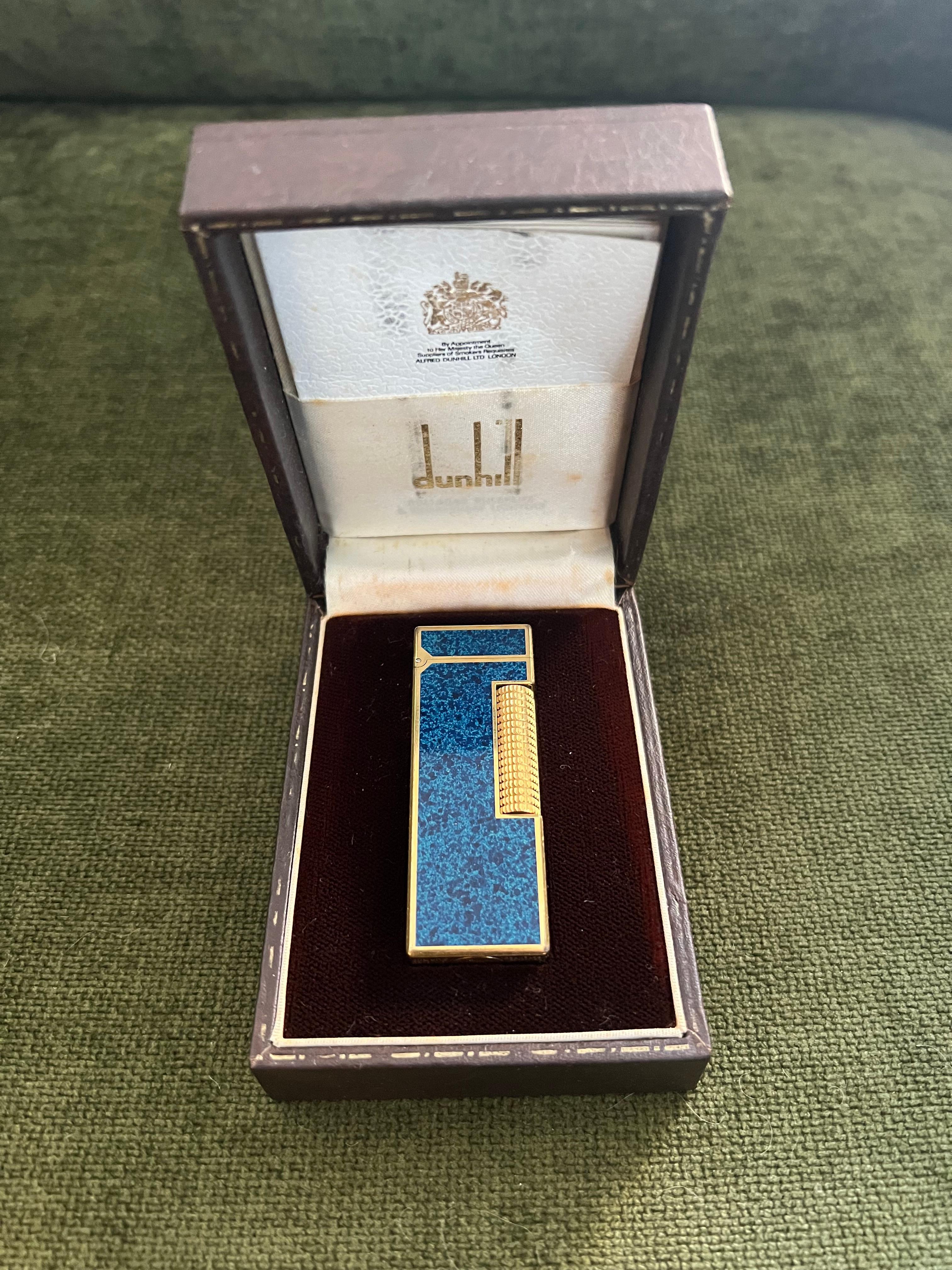 Rare Vintage Dunhill Gold Plated Blue Marble Lacquer Lighter Original Case 
Circa 1970

Rare Vintage Dunhill gold plated Blue Marble lacquer Swiss Made lighter In mint condition.
Works perfectly. 
Iconic and beautifully engineered piece with rare