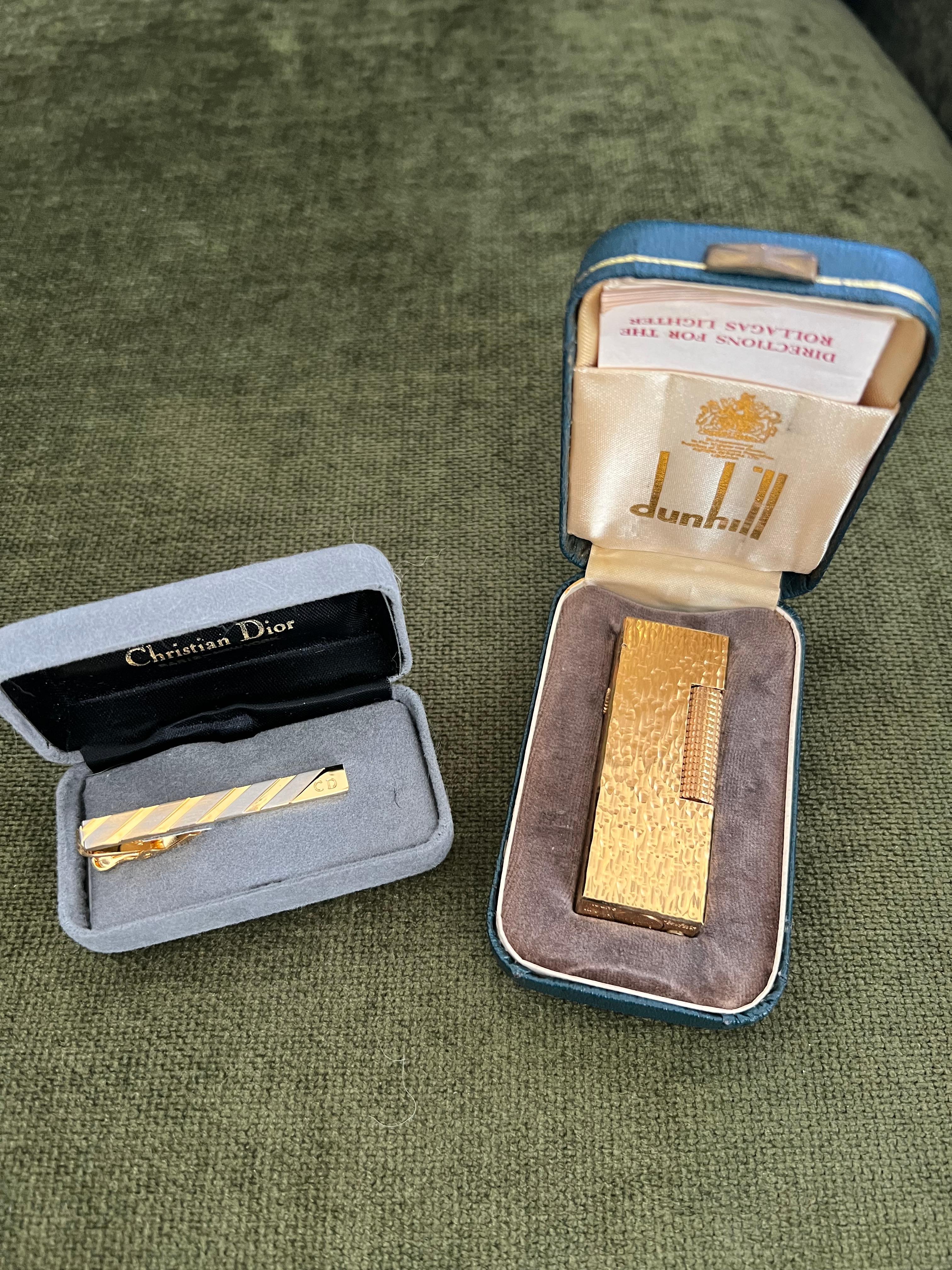 Rare Vintage Dunhill Gold Plated Lighter & Christian Dior Neck Tie Gift Set 

Vintage Christian Dior Gold Plated & Black Enamel front Logo Neck Tie 
Christian Dior's influence on fashion is immeasurable. His daring vision, meticulous craftsmanship,