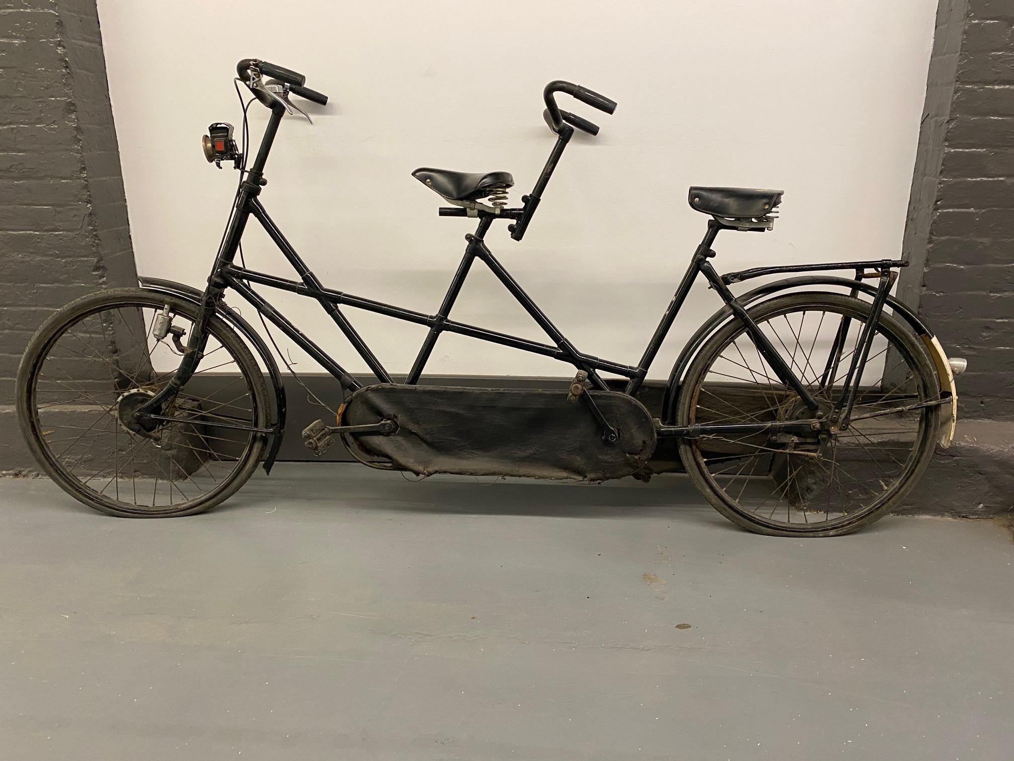 Rare Vintage Dutch Tandem Bicycle by Burgers including a Tajindia Rolex oil bicycle lamp.
Measures: Seat height in front 36 in. seat height in the back 35 in.

The history of Burgers goes back almost 150 years. In 1869, the blacksmith Henricus