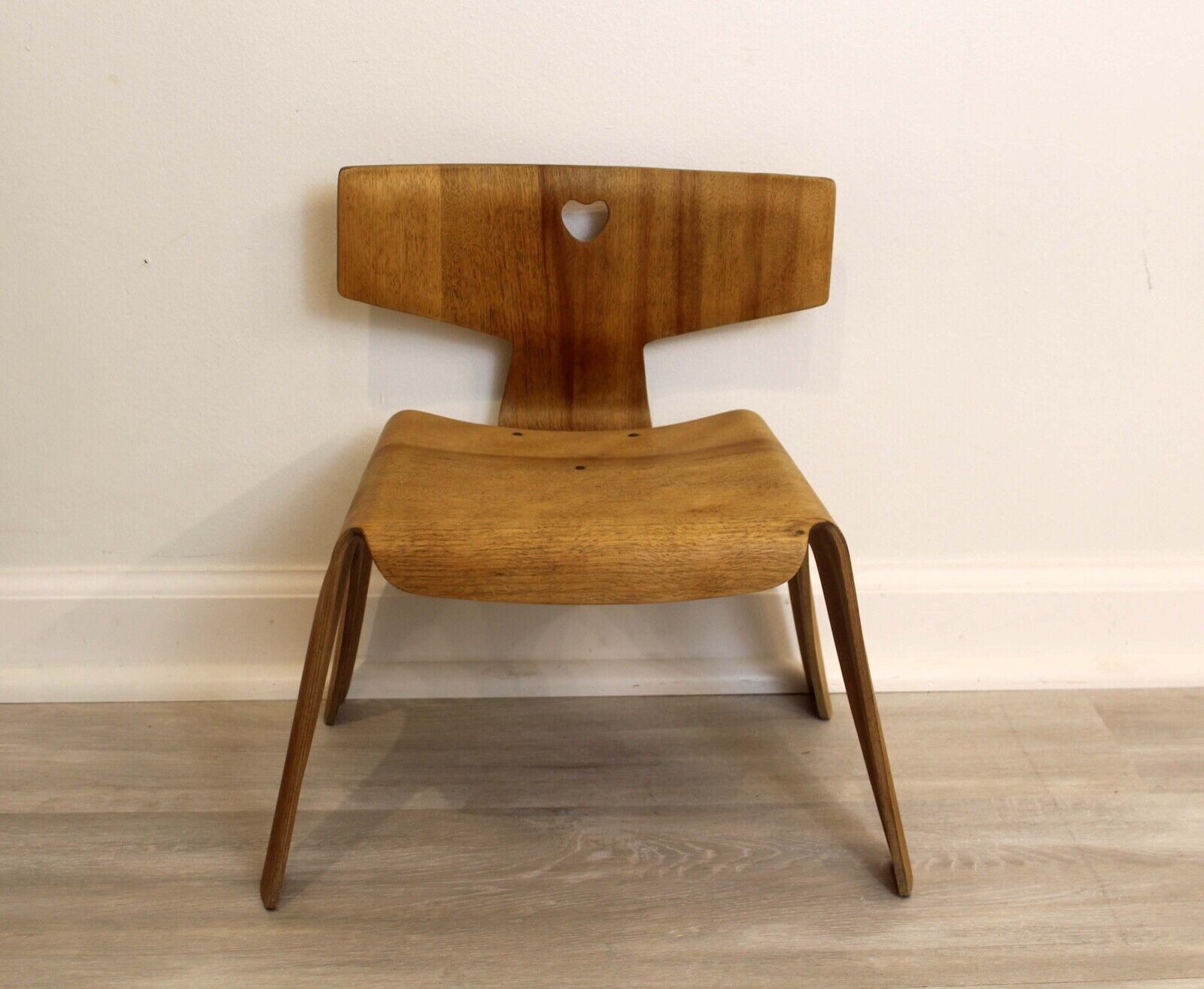 Super rare!! The Eames Nested Childrens chair was made from two sections of five layers of molded plywood. The top spine was attached to the lower seat part by way of 3 rivets in a triangular pattern. The beautiful curved forms of the chair were