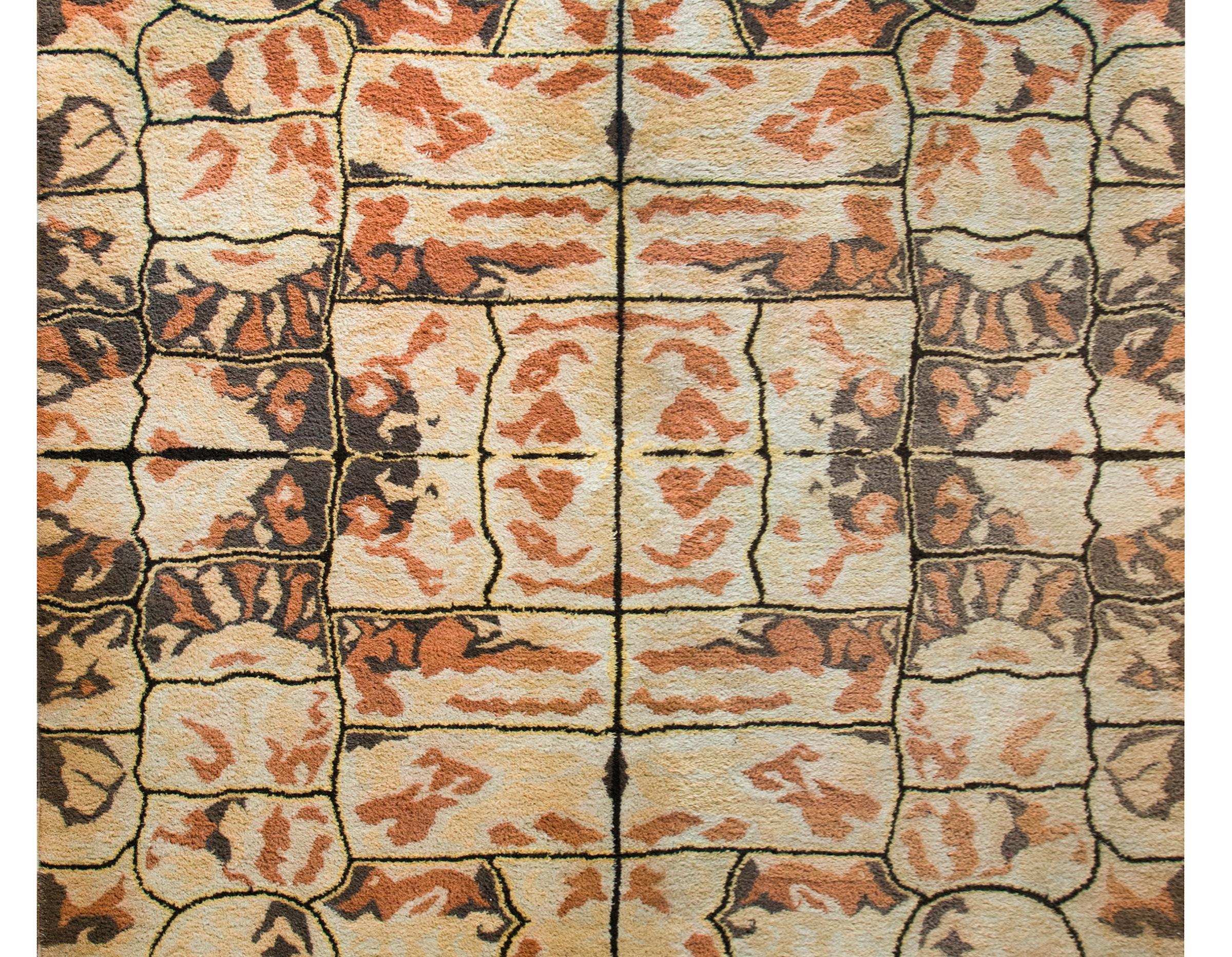 A rare mid-20th century Ecuadorian hand-knotted wool rug with a mirrored pattern of abstract reptile scale patterns, or up-close floral patterns, or distorted landscape patterns, all woven in earthy brown, cream, yellow, and orange tones.