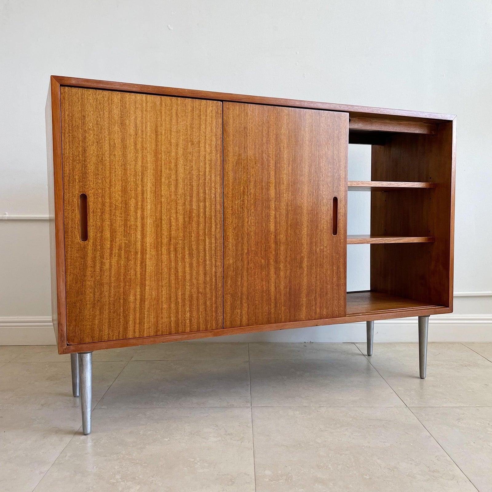 Custom designed by Edward Wormley for Dunbar this cleverly designed walnut credenza, sideboard, room divider has 3 sliding doors on both sides revealing shelving on either side. This is perfect to float in a room as it can be accessed on both sides,