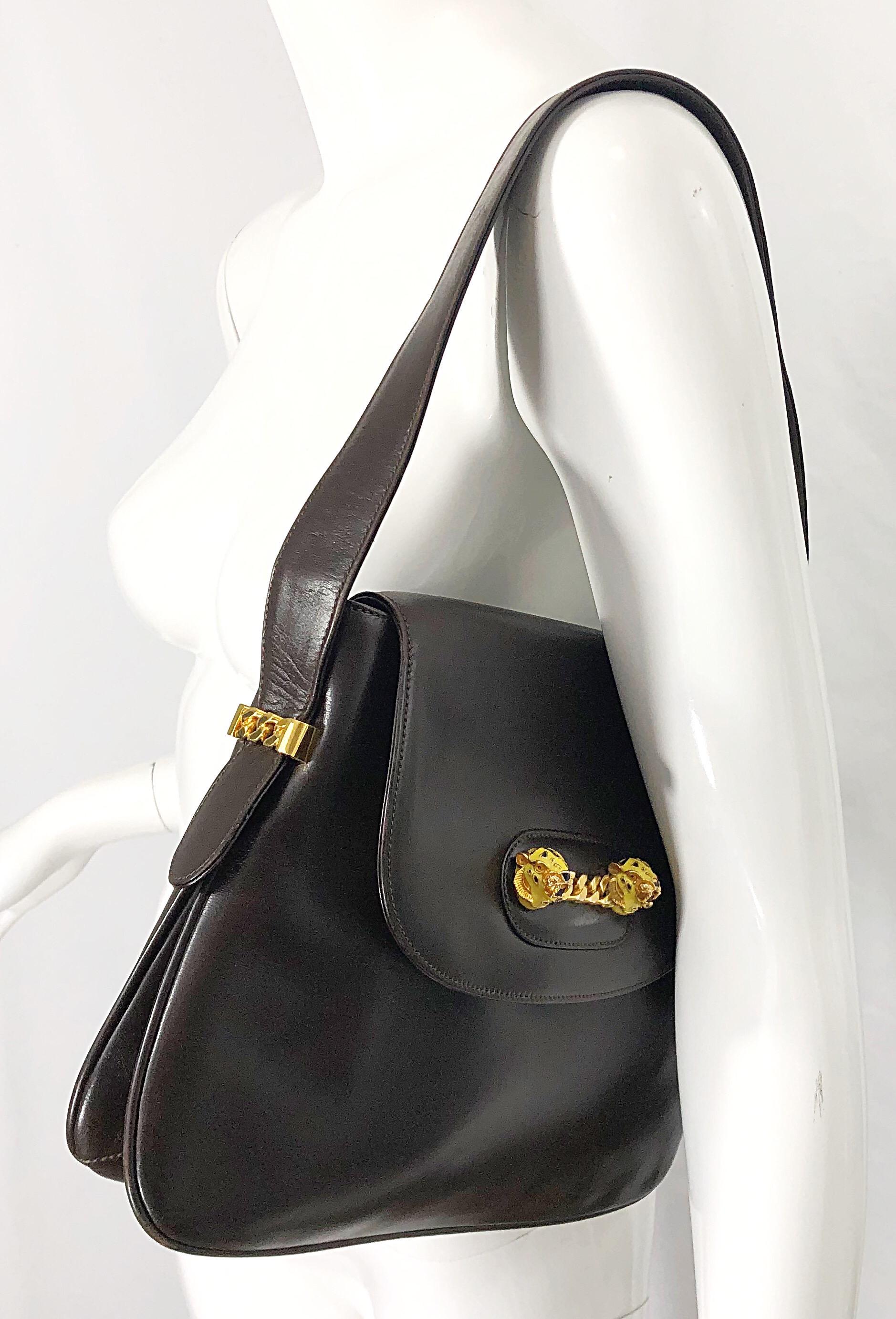 Rare and equally as chic 70s GUCCI chocolate brown leather shoulder bag ! Features the perfect brown color that goes with anything, anytime of year. Flap closure with pockets inside. Gold chain details with yellow painted enamel tigers on the front