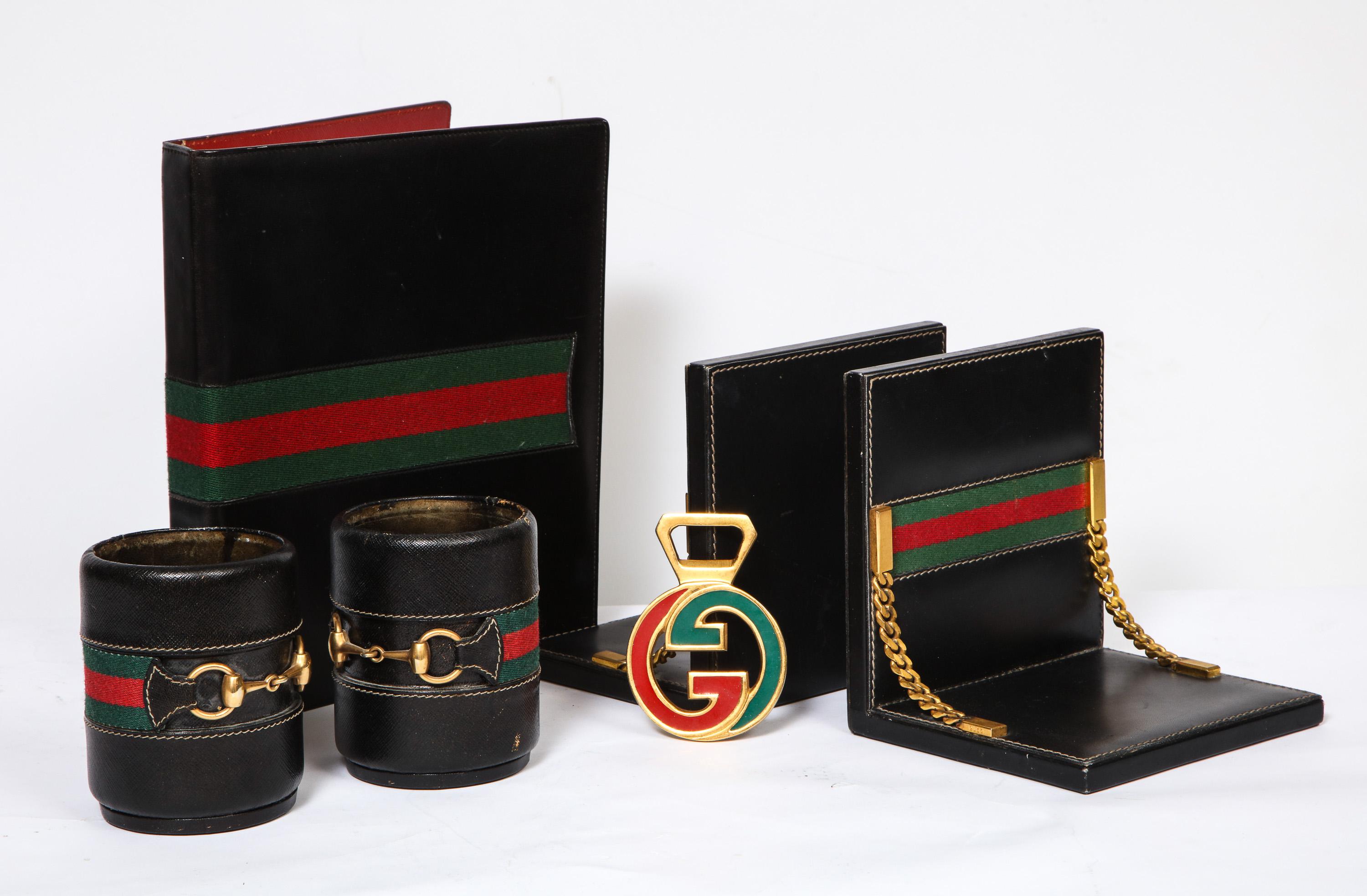 Rare vintage Gucci 8 piece executive Italian leather desk set accessories, 1979
 
Made from black leather with green and red stripes. 

Includes: 
Planner binder with calendar inserts from 1979, and notebook. All original and unused.
Pair of