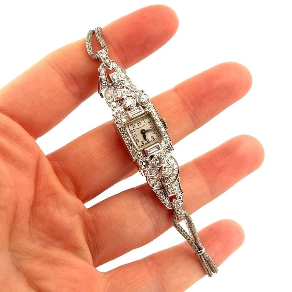 Complete service 5/2025

Presented here is a beautifully preserved vintage Hamilton ladies' wristwatch, showcasing classic craftsmanship with a platinum case and sparkling natural diamonds throughout. The case measures approximately 14mm wide and is