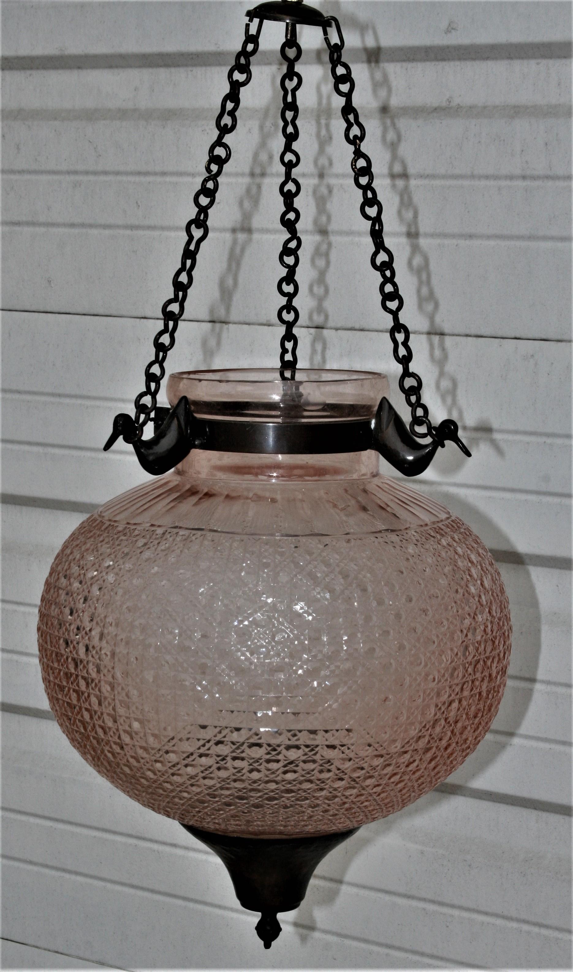 A large dome shaped handcut crystal glass hanging lantern. The Fine handcut on the crystal and the dreamy champagne shade on the globe make this an extraordinary piece. Three hand forged iron chains hold the crystal globe through three brass ducks