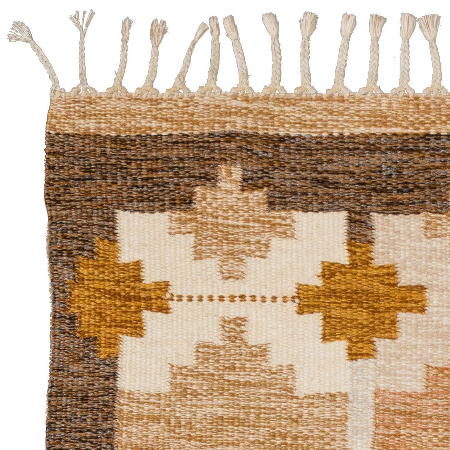 This rug is all about a warm and sunny feelings. Woven circa 1960s with a distinctive color palette in warm yellow, brown-yellow and purple. Handwoven rare pattern designed and signed IS, famous Swedish designer Ingegerd Silow. She was one of the