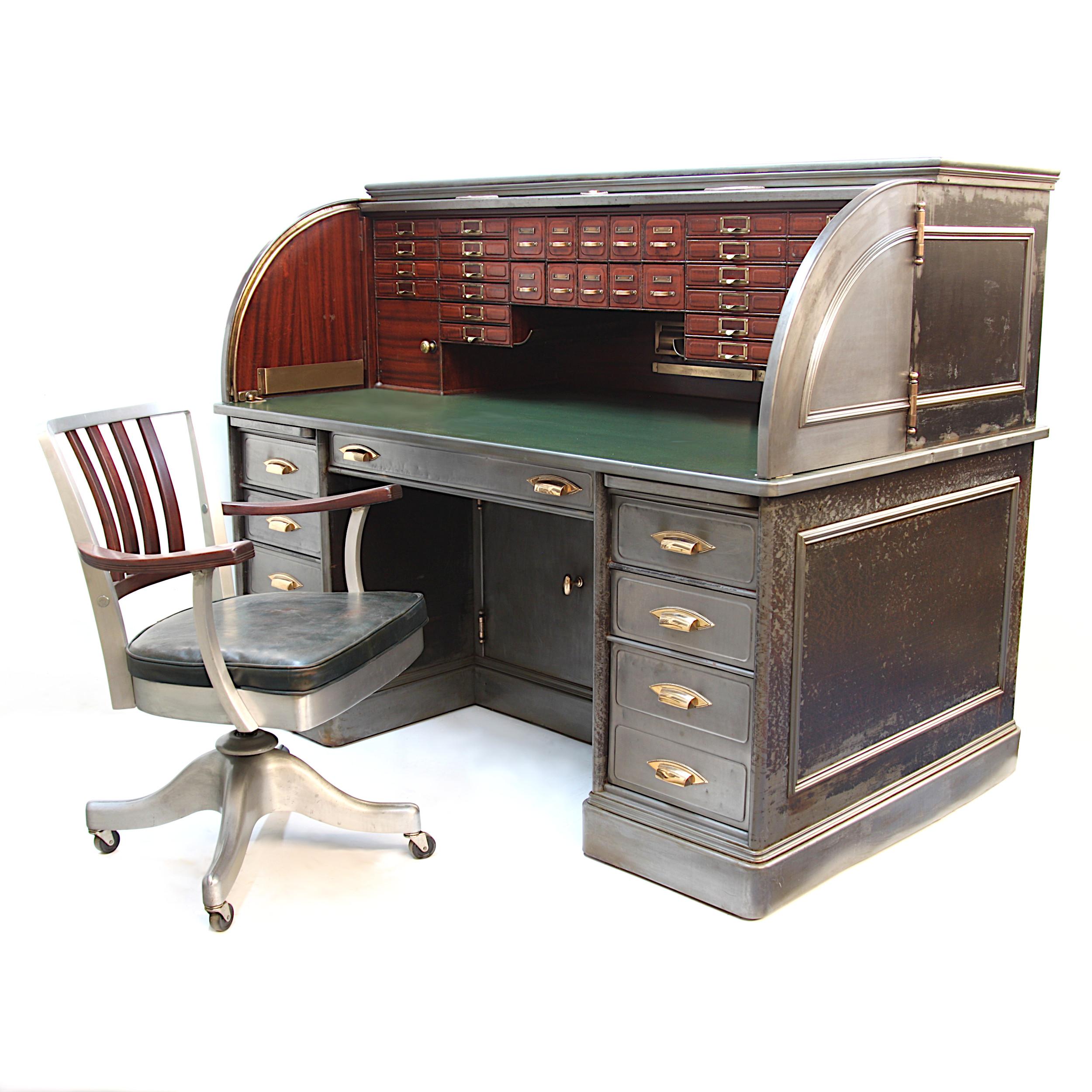 This is an absolute stunner of a roll top! Manufactured by the Art Metal Construction Co. of Jamestown, NY around the turn of the century, this monumental desk is built like a battleship and features nearly as many bells and whistles!

Desk