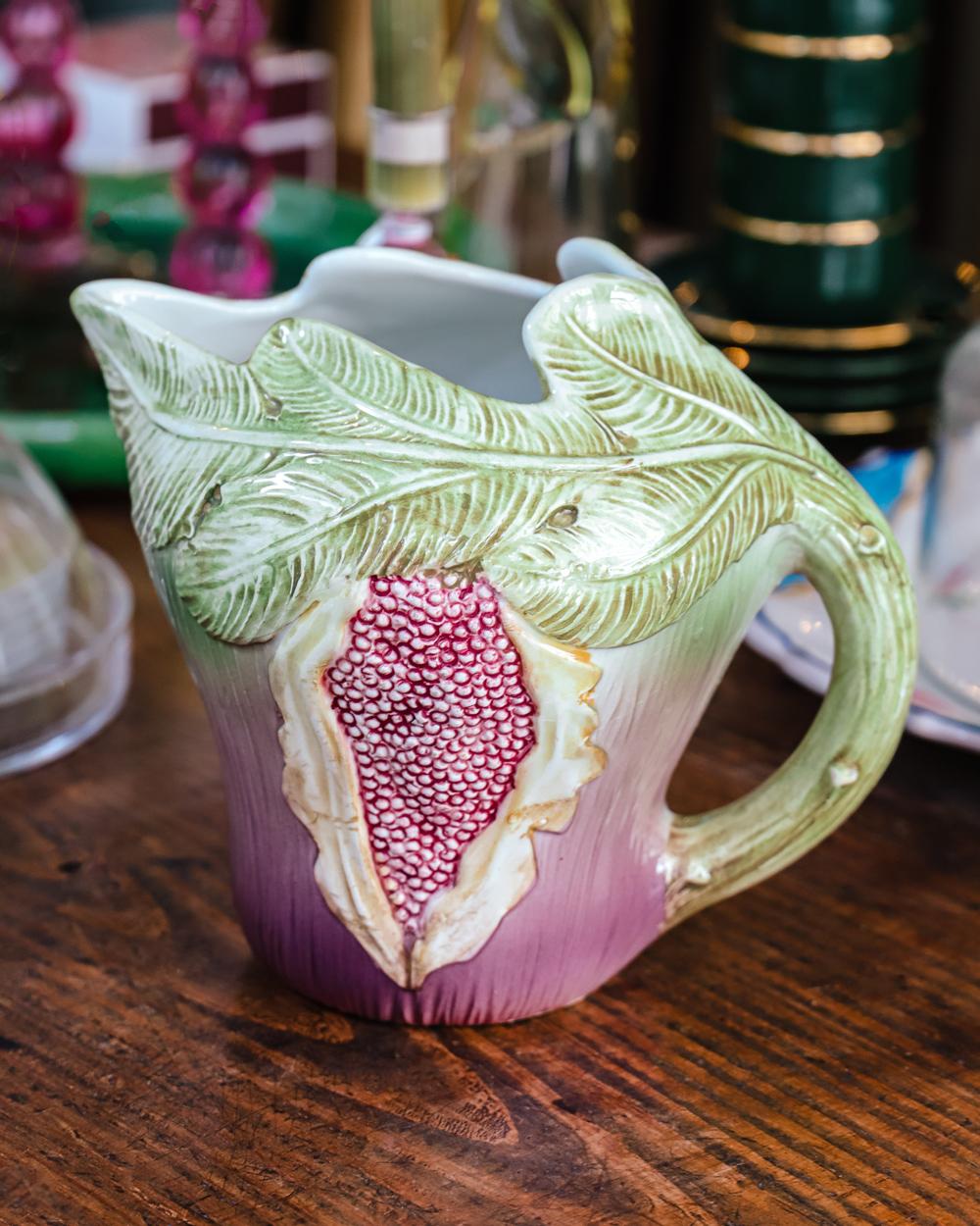 Stunning and rare vintage Italian fig-shaped pitcher, crafted in multicolor glazed ceramic from the 1950s-60s. This eye-catching piece features soft, attractive hues that bring a lively accent to any kitchen or dining table.

Ideal as a serving