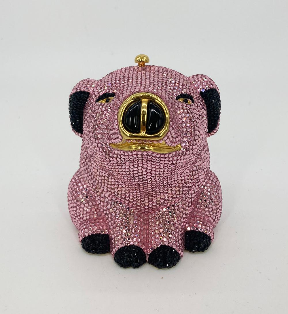 Rare Judith Leiber Pink Crystal Pig Minaudiere in very good condition. Pink swarovski crystal body with black crystal feet, eyes and ears. Gold snout/smiling mouth with large black gemstone nose. Top button closure opens to a gold leather interior