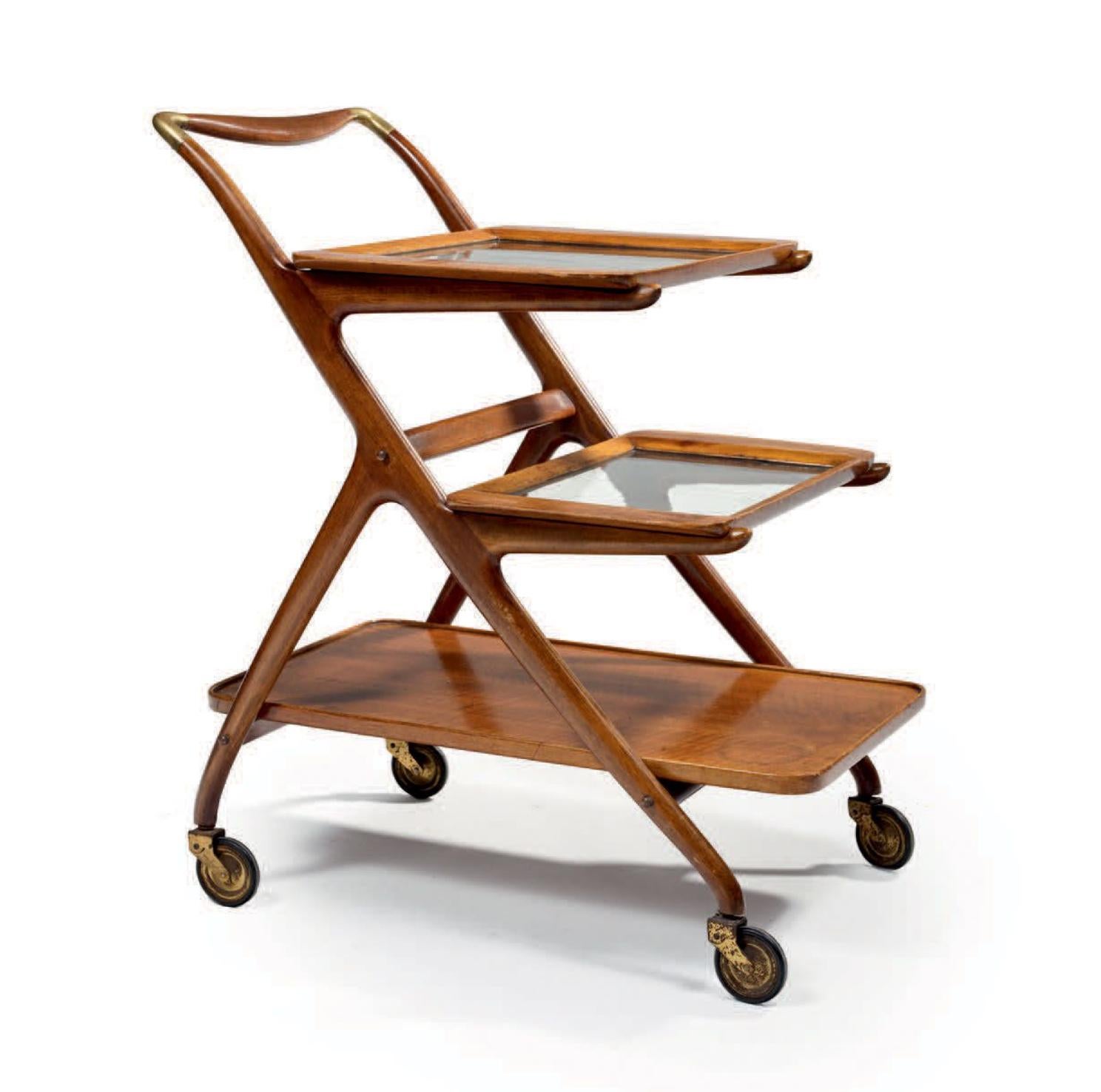 Rare early 50s mahogany trolley designed by Ico Parisi.
It is on three levels two of them with glass and there are small brass fine details on the corners.
The structure is made of polished mahogany with rounded and beveled corners bent wood