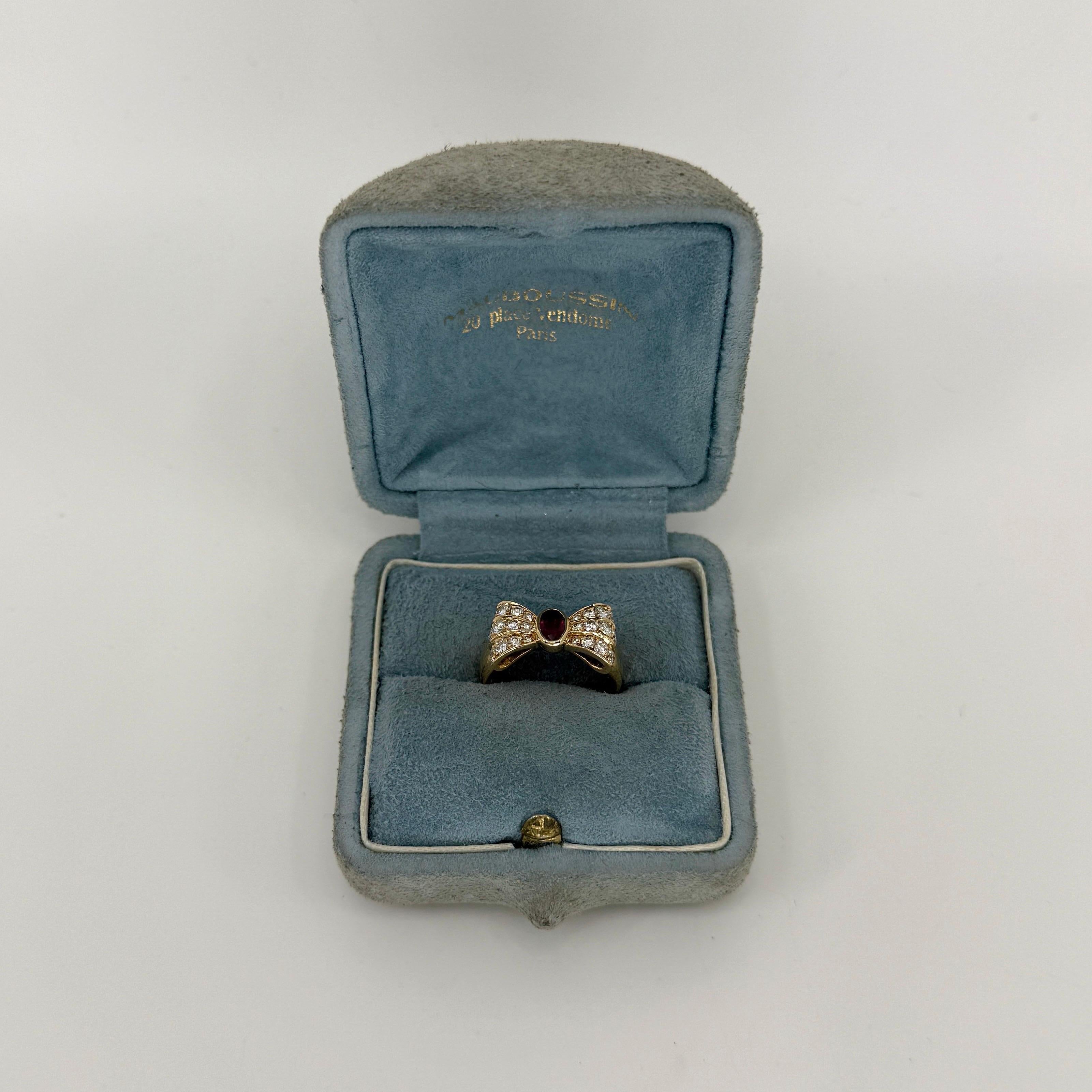 Rare Vintage Mauboussin Deep Red Ruby And Diamond 18k Yellow Gold Bow Ribbon Ring.

A stunning vintage ring with a unique design from fine French jewelley house Mauboussin, set with a bezel rubover oval cut natural ruby and natural diamond