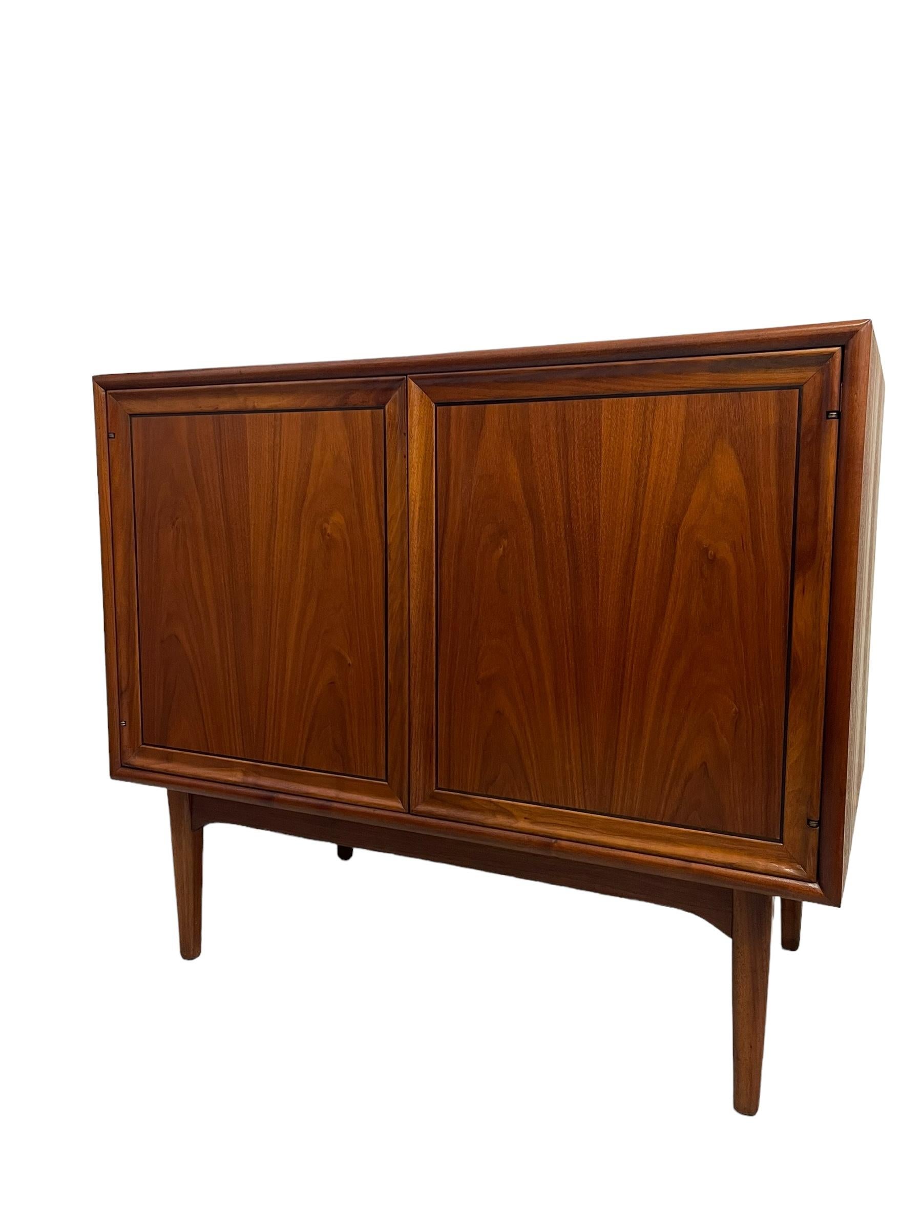 Beautiful Mid-Century Modern richly grained walnut double door cabinet designed by Kipp Stewart and Stewart MacDougall for Drexel's Declaration Collection, circa 1960's. Expertly crafted, remaining in clean vintage condition with a solid,