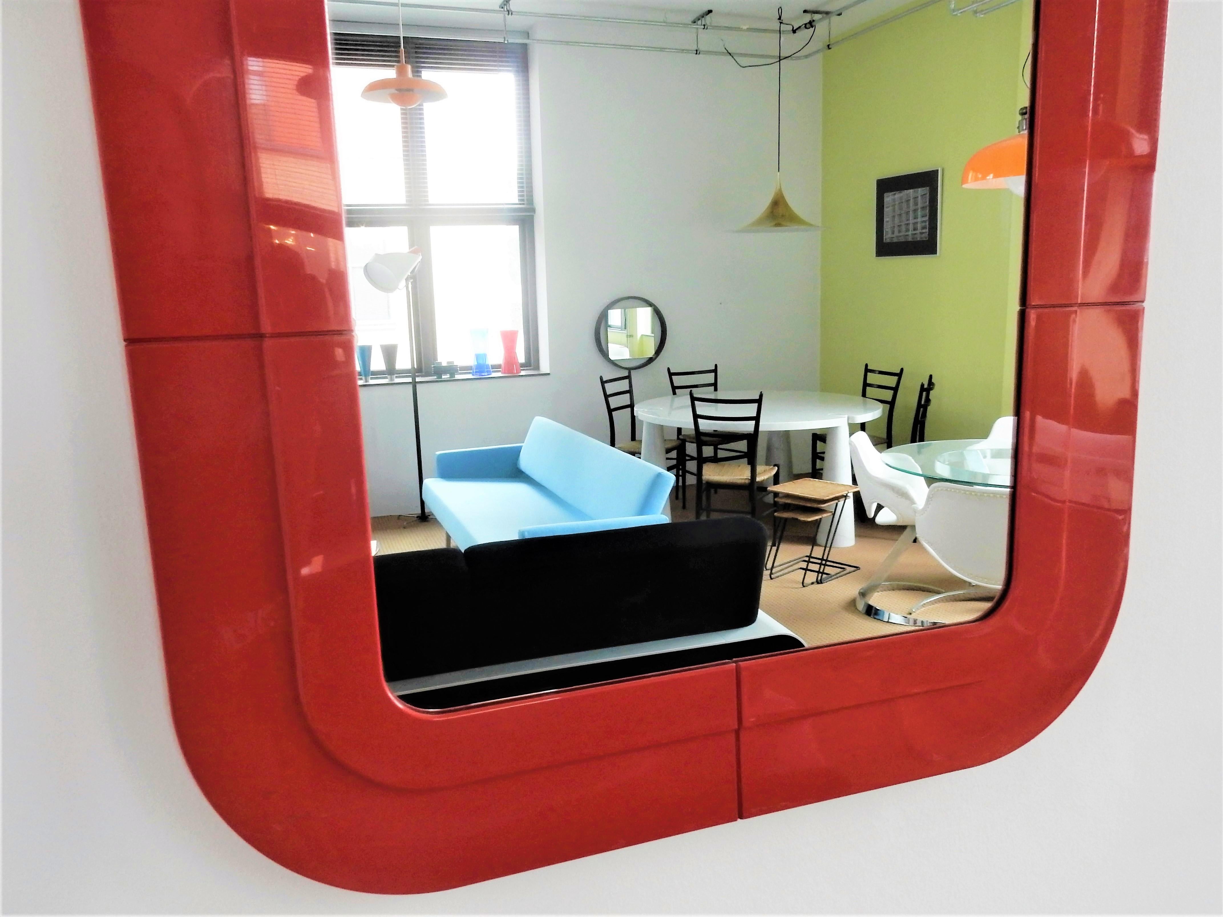 This very nice moulded red plastic frame mirror with is designed by the Italian designer Anna Castelli Ferrieri and manufactured by Kartell in the 1960s-1970s. A model not often seen, particularly in this bright red color. The mirror is marked at