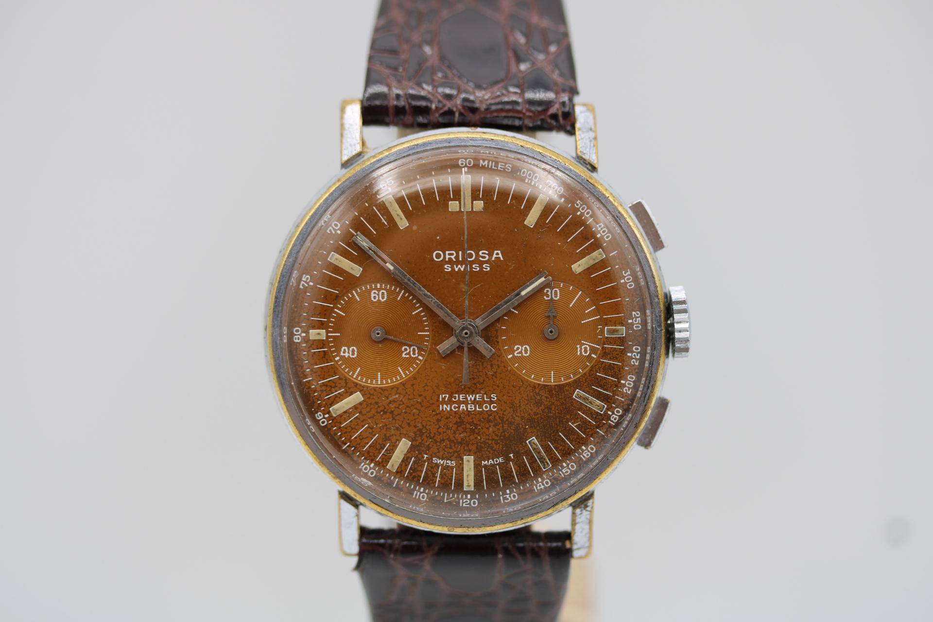 Rare Vintage Oriosa Chronograph – 1960s  Stunning Tropical Dial

The Oriosa Chronograph is a vintage timepiece from Oriosa, a lesser-known Swiss brand that gained popularity in the mid-20th century. Oriosa was known for producing reliable mechanical