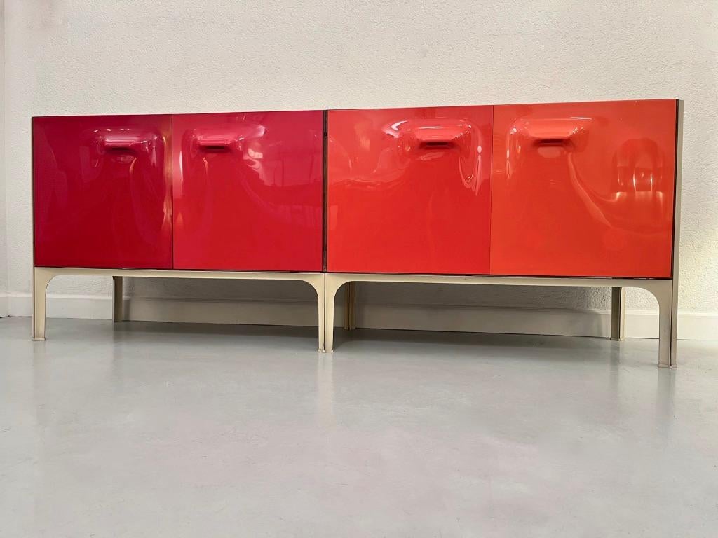 Rare vintage sideboard from the DF2000 series sideboard by Raymond Loewy produced by C.E.I., Compagnie d'Esthetique Industrielle.
4 doors with a degraded of red to orange. 3 orange and red drawers and 2 bottles holders drawers.
2 cabinets on the