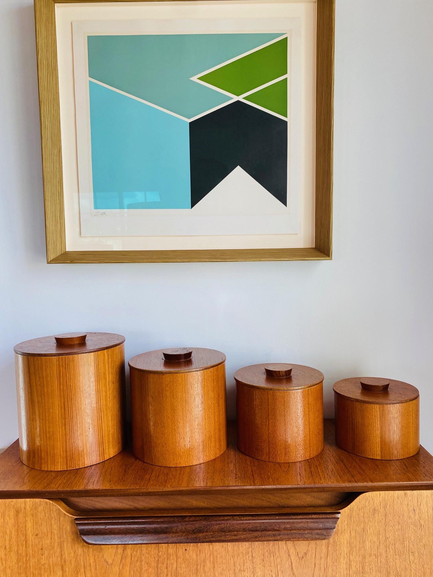 Beautiful set of teak canisters.  This vintage set is aesthetically pleasing visually and current, as it is full of purpose.  The practicality of the nesting ability adds excitement to their placement and use.  The minimalist nature makes it modern