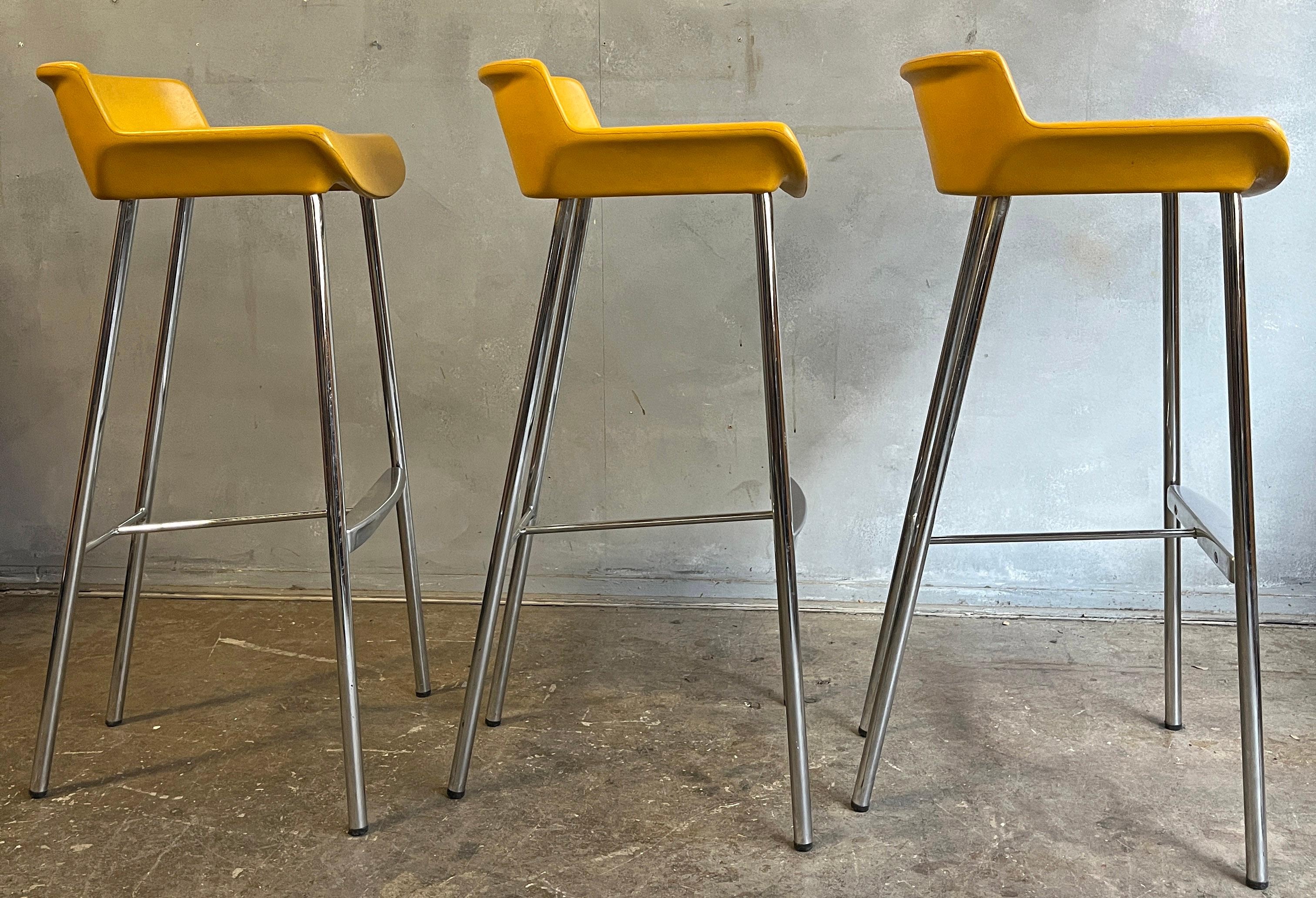 Rarely found stools designed by Jorge Pensi with yellow seat and chromes legs. Post modern / Mid-Century design. We think this is the most beautiful stool ever made. Simple and elegant. Incorporated aluminum foot rest into chrome legs with a modern
