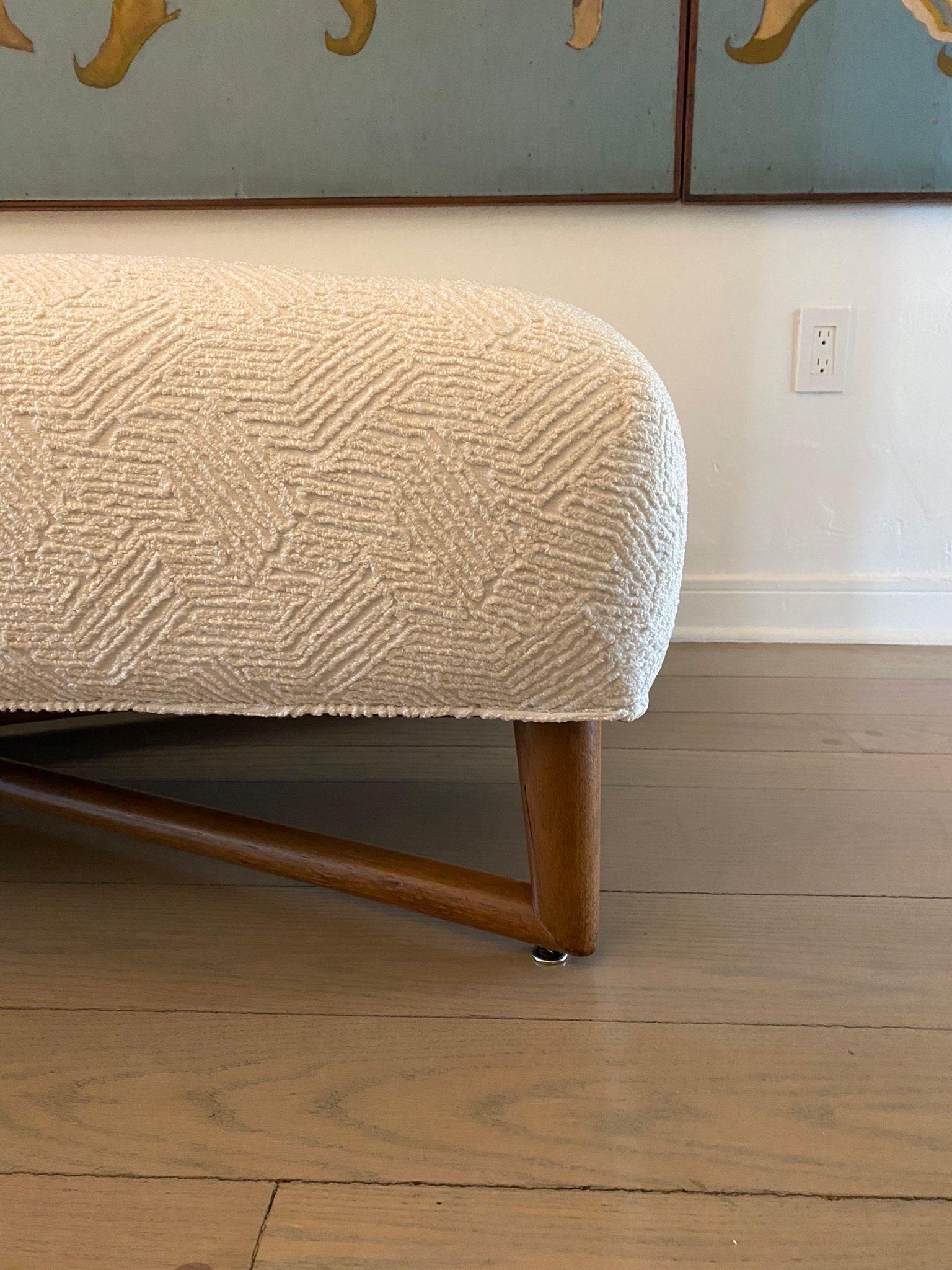 A VERY comfortable walnut wood X-frame base bench which is likely a special commission for Robsjohn-Gibbings. We have TWO benches, sold separately. Newly upholstered.  THIS ITEM IS LOCATED AND WILL SHIP FROM OUR EAST HAMPTON, NY SHOWROOM.