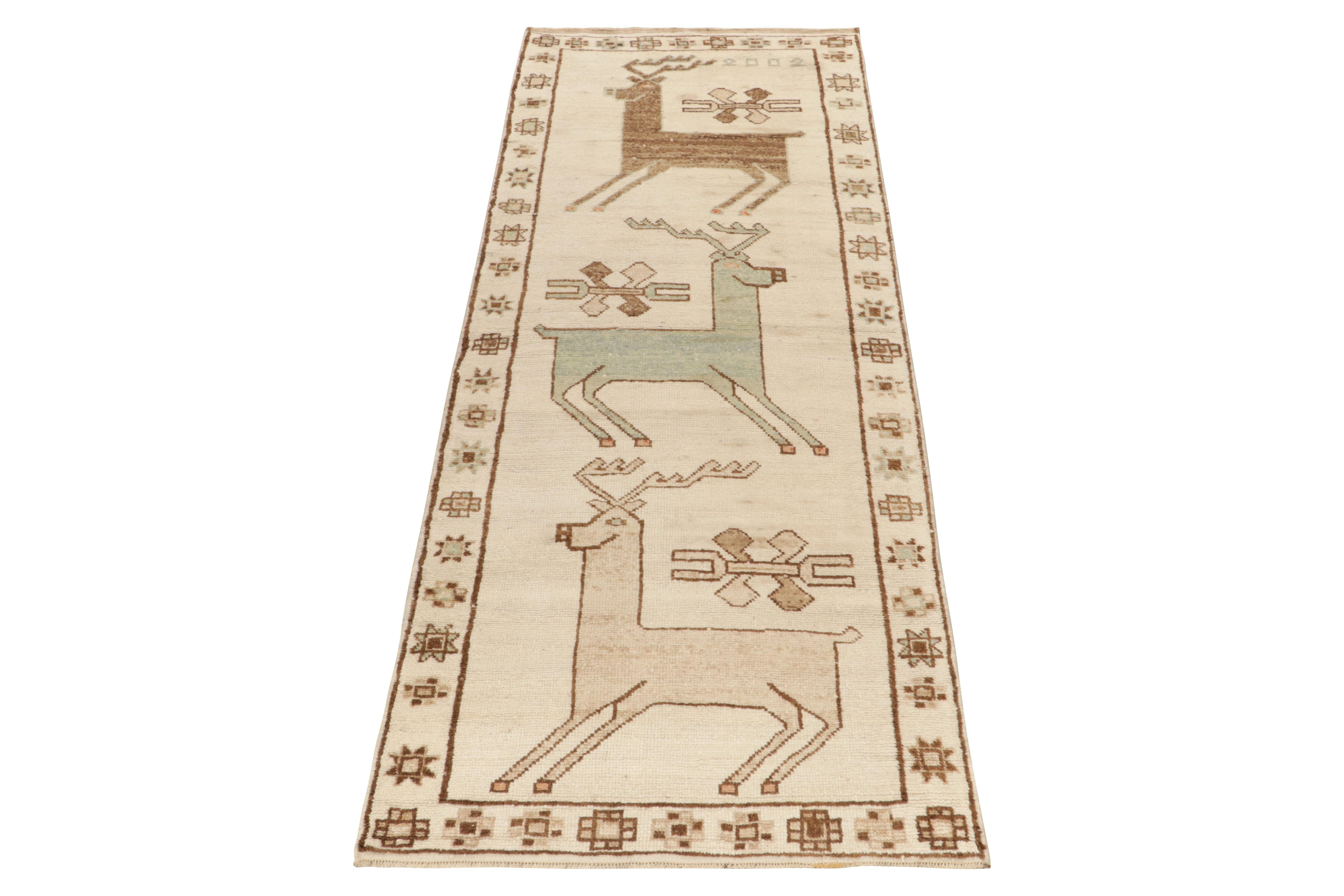 From Rug & Kilim’s vintage selections, a 4x11 hand-knotted wool rug connoting rare nomadic sensibilities. 

Originating from Turkeycirca 1950-1960, the tribal piece showcases graphic deer pictorials in beige-brown and blue-green tones—further