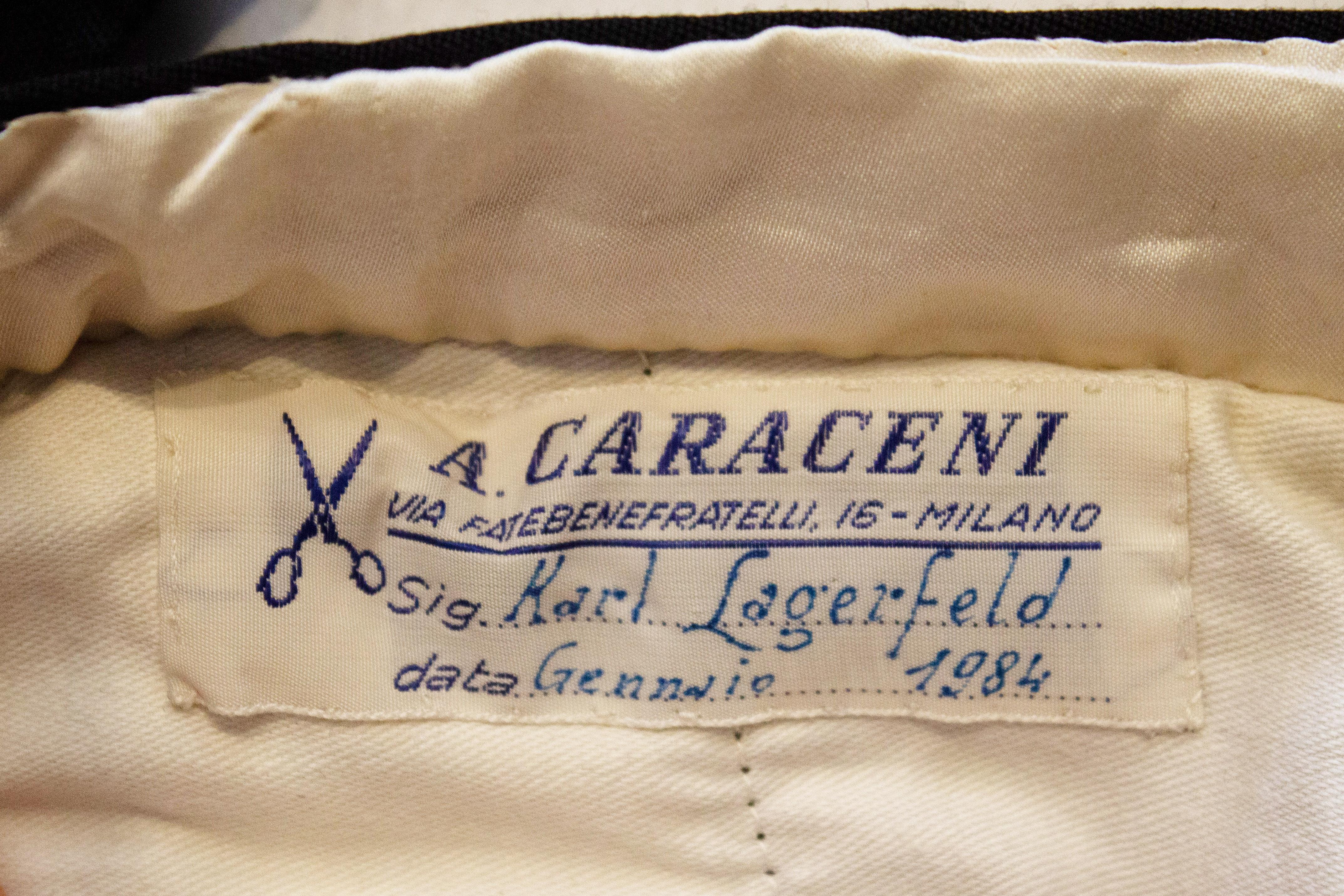 A rare and beautifully made pair of black trousers by A Caraceni, Milan, . These were made for Karl Lagerfeld in 1984.  They have a button fly opening, with two back pockets and one pocket on each side. There is a black ribbon along each out side