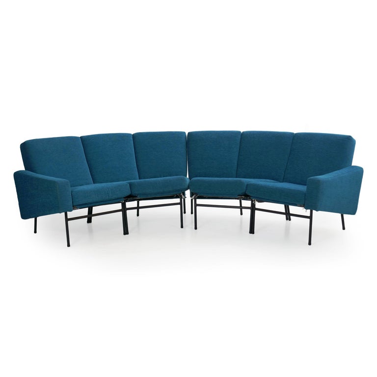 A gorgeous and rare model L-10 curved sofa designed by Pierre Guariche, the present example features a delightful blue covering over black enameled iron frame. It is built in two parts to allow a variety of situations, either as a singular unit or